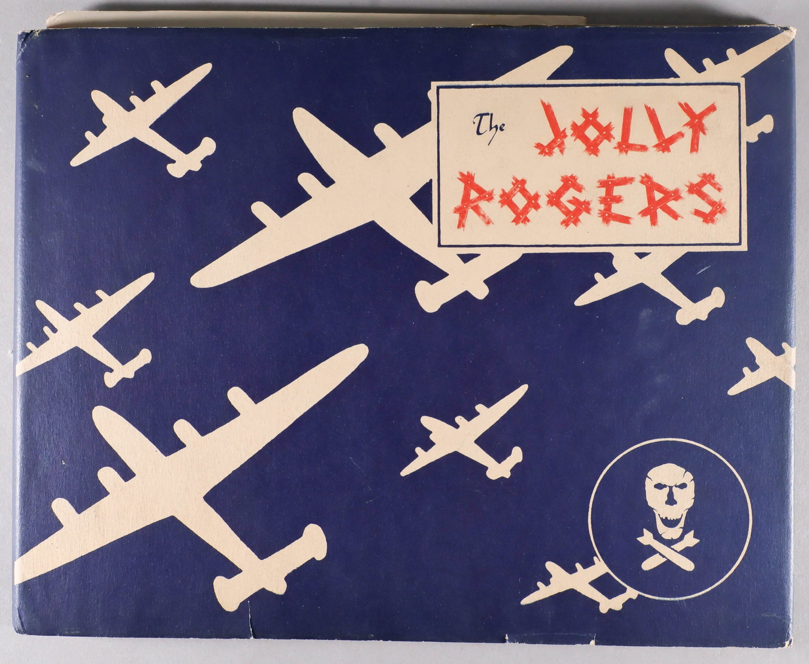 'JOLLY ROGERS' 90TH BOMBARDMENT GROUP 1944 UNIT HISTORY: Rare war-date unit history 'The Jolly Rogers' [Sydney: John Sands Pty. Ltd.], 1944. 112pp. 11 x 8.5 in., illustrated boards with red cloth spine, fine with excellent dust wrapper. A great war-date