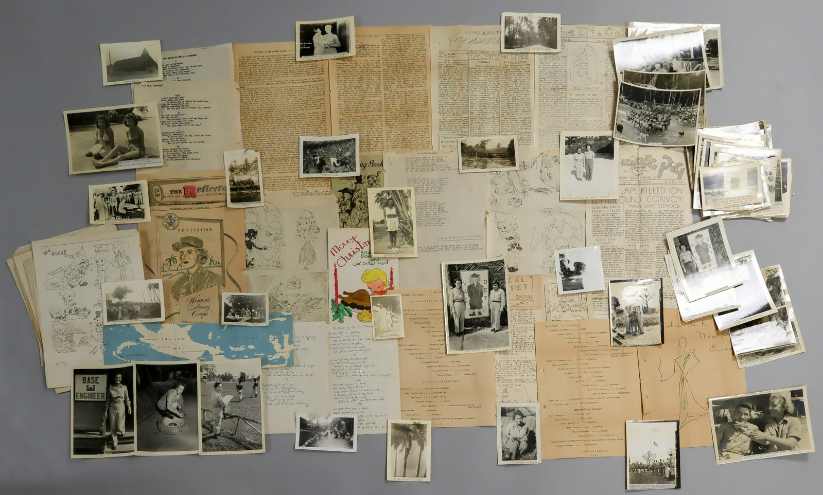 WACS IN NEW GUINEA PHOTO AND EPHEMERA: The grouping includes approx. 50 original photographs, average size about 4 x 6 in., largely individual and group shots in fatigues, also including the WACS marching in formation, various structures