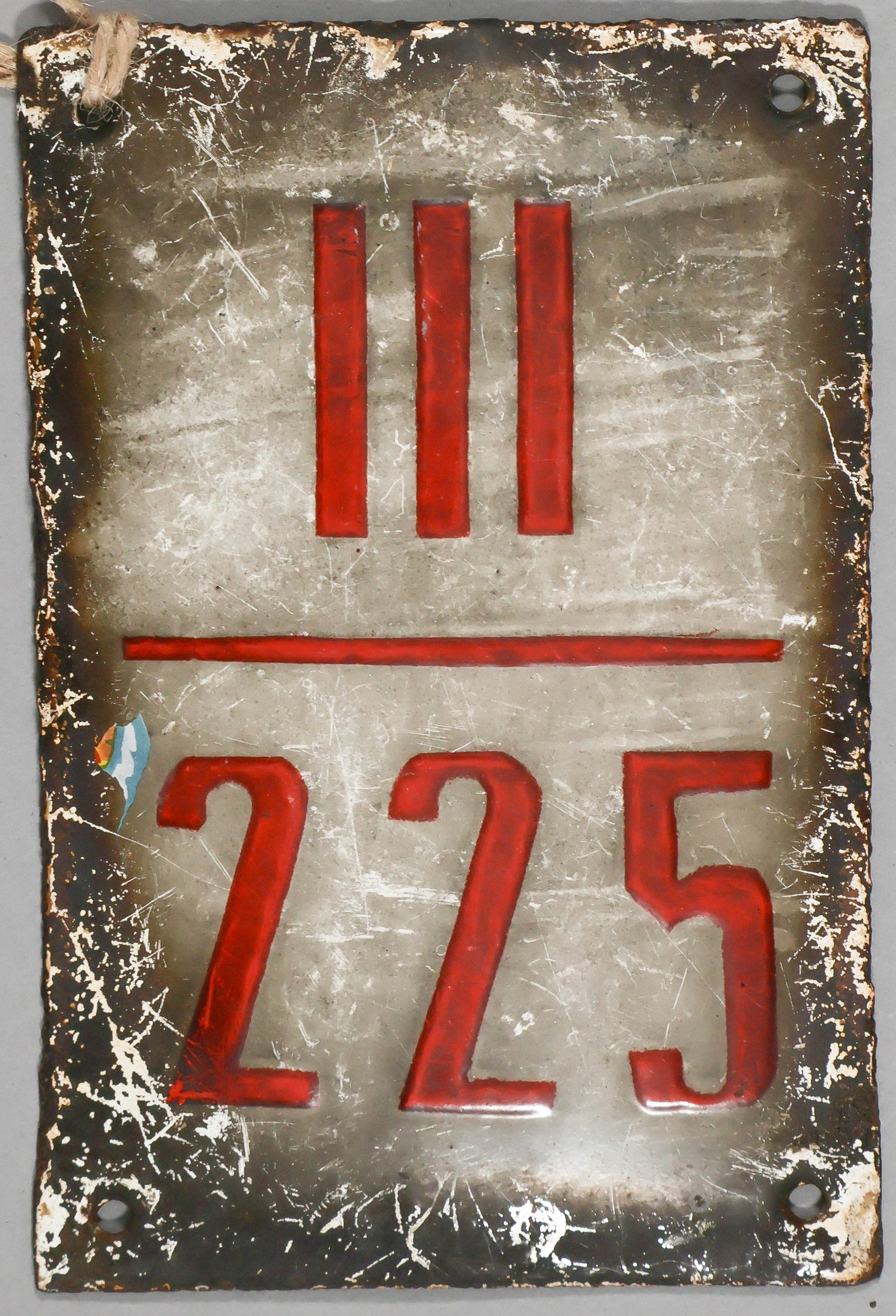 THE GREAT ESCAPE: STALAG LUFT III HUT SIGN: A great relic from the ‘X’ Compound of Stalag III, a metal sign for Hut 225 measuring 6 x 4 in., with the enameled front reading ‘III 225’. This hut, one of 15 single-story