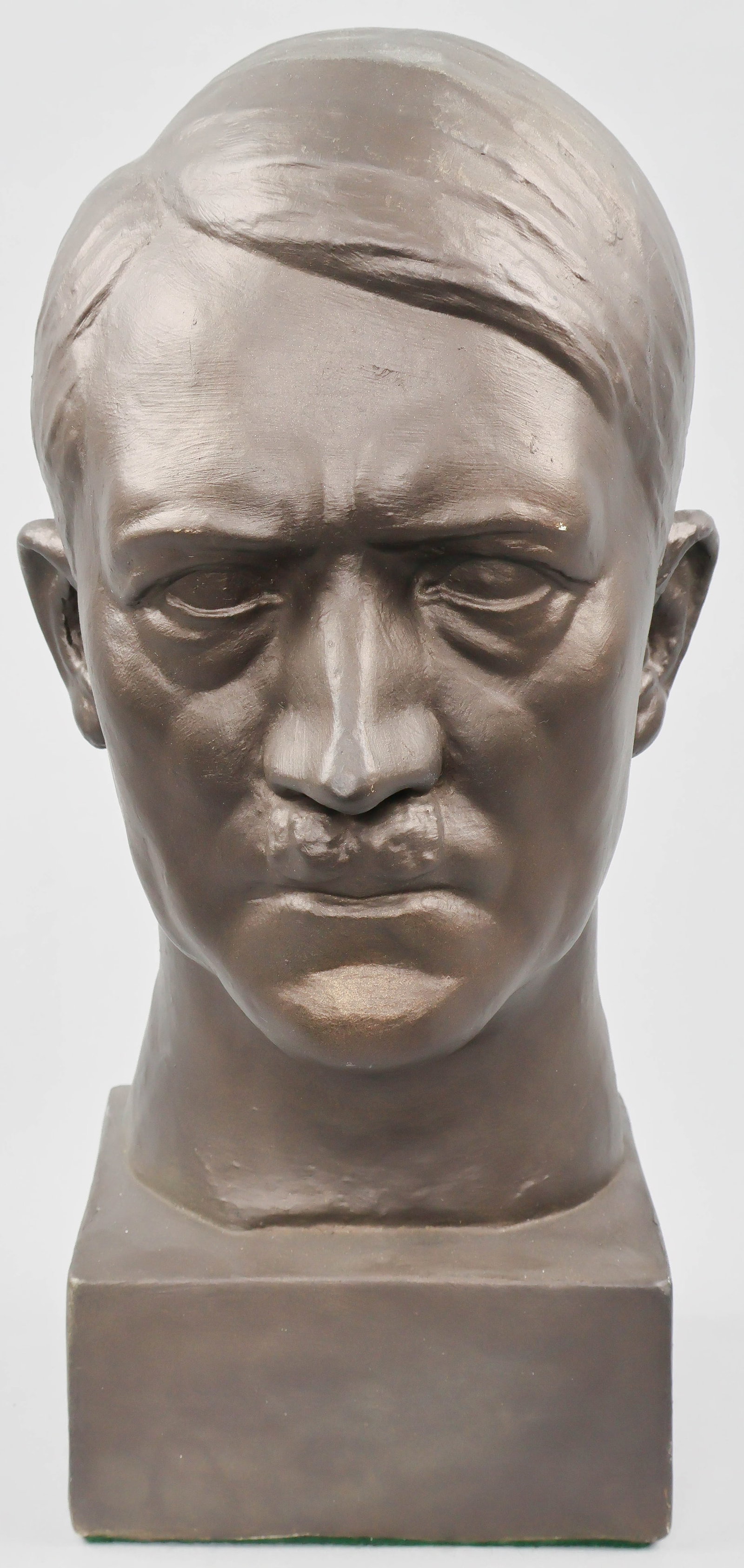 BUST OF ADOLF HITLER: A handsome ceramic bust of Hitler, 14 in. tall on a 5 in. square, glazed in bronze and exhibiting a high level of detail. Not signed. One tiny blemish at right eyebrow, else very good to fine