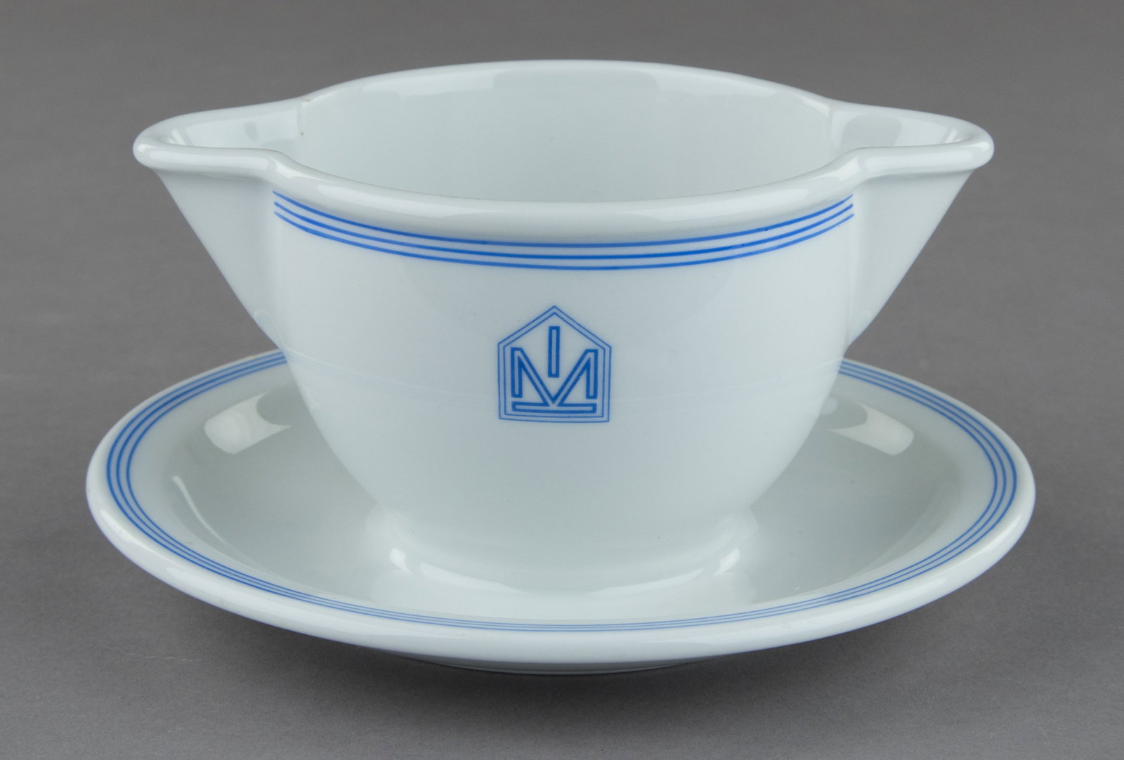 D.A.F. ‘BEAUTY OF LABOR’ PORCELAIN GRAVY BOAT: A German made porcelain gravy boat, 7 in. wide and 4 in. tall. The bottom displays the insignia of the DAF (‘German Labor Front’) suborganization Schonheit der Arbeit ('Beauty of Labor'),