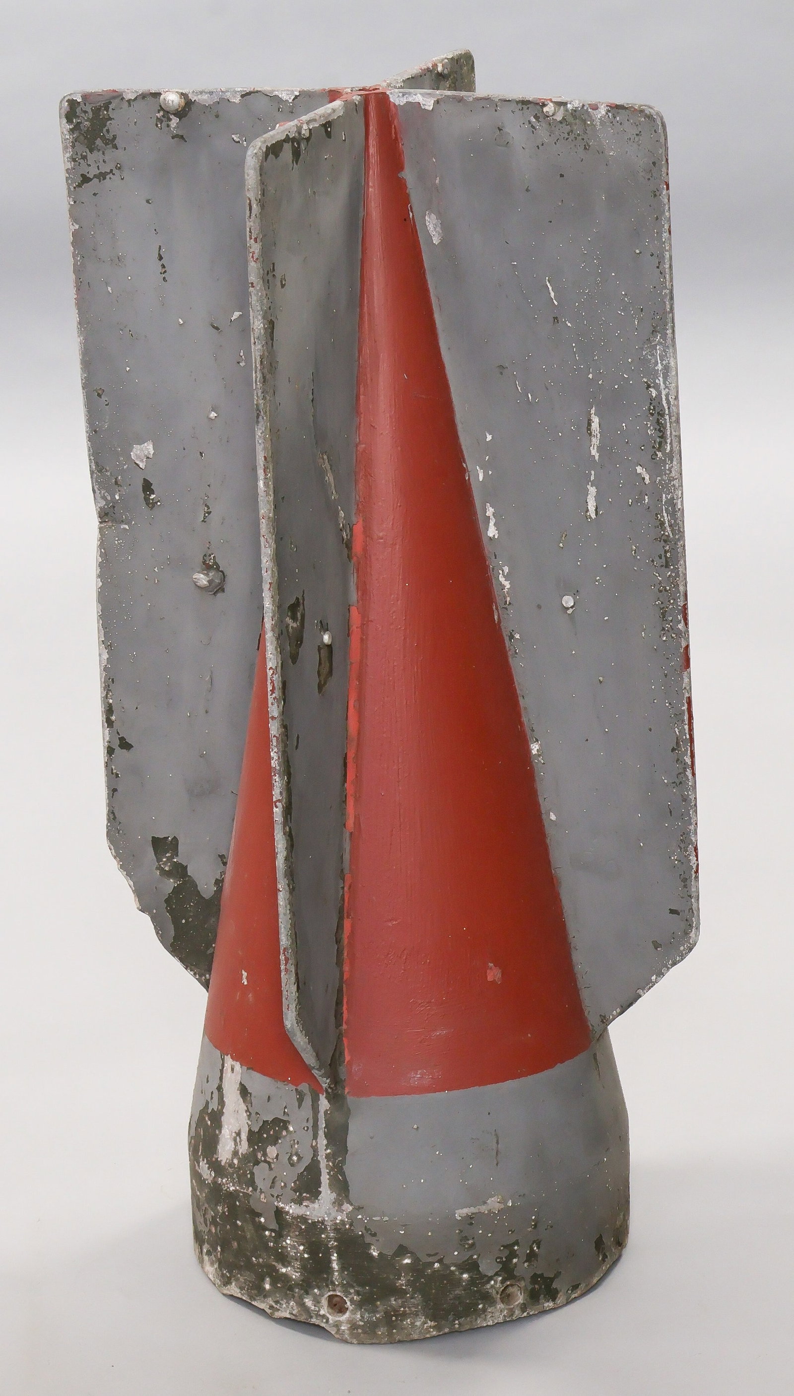 GERMAN AERIAL BOMB TAIL FIN: German metal alloy aerial bomb tail section, 21 tall, 8 in. diameter, with four fins projecting from the bottom of the casing and with eight machine screw bolt holes for attachment to the explosive