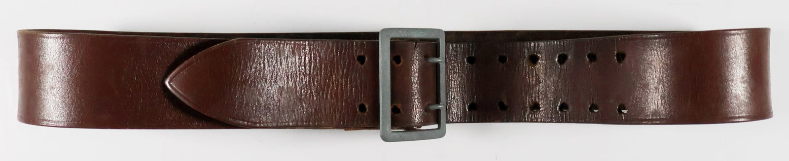 GERMAN ARMY OFFICER’S BROWN BELT: German Army officer's brown leather belt, 34 in. x 1.75 in., with 10 rows of two holes, manually enlarged for faster buckling. Belt is fitted with an unmarked claw buckle in natural metal finish, and