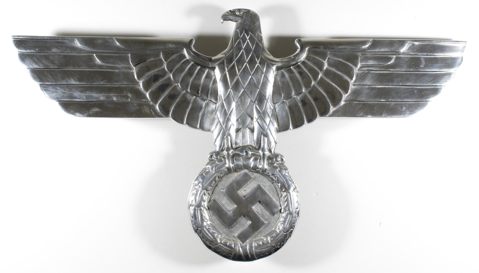 GERMAN RAILWAY EAGLE (POST-WAR): Iconic German Reichsbahn eagle, bearing the national eagle and wreathed swastika of the Third Reich period, 27.5 in. wingspan x 15 in. top to bottom, bears a small and crude impression stamp of: