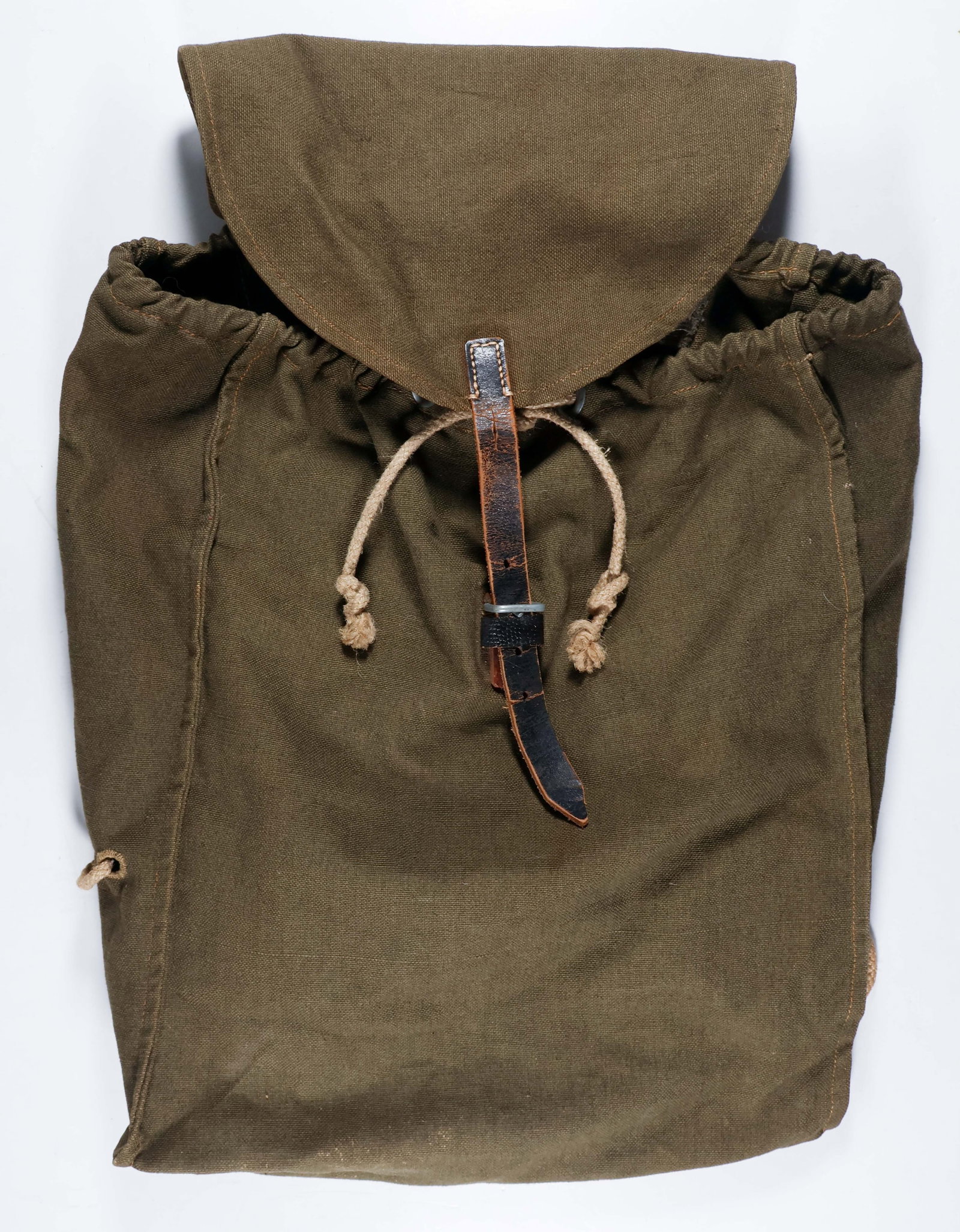 GERMAN RUCKSACK: German Army rucksack, 14 in. x 15.5 in., in field gray canvas construction. Top flap closed at the front by a black leather strap and buckle. The top closure of the pack can also be pulled tight with