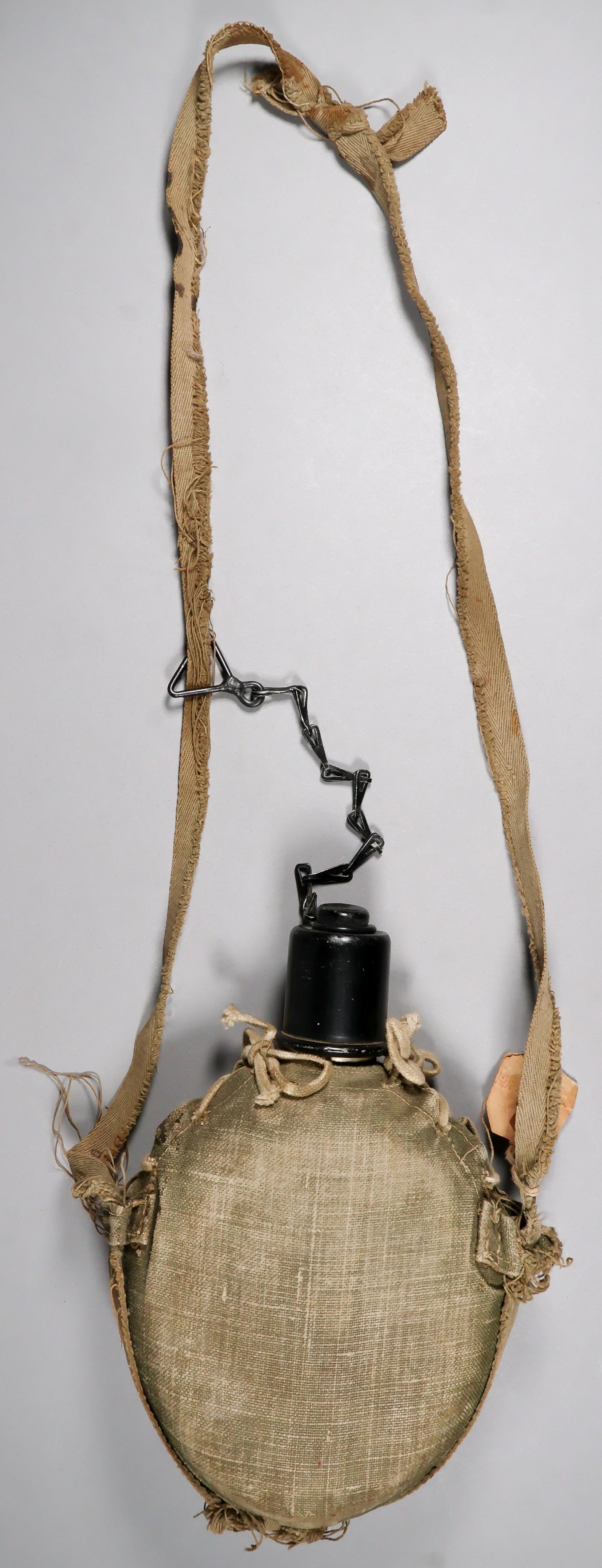JAPANESE NAVAL LANDING FORCES CANTEEN: Japanese Naval Landing Forces aluminum canteen with a light green cotton cover and a screw-off aluminum cap. It comes complete with its adjustable canvas shoulder strap. Dimensions 9 x 6 in. incl.