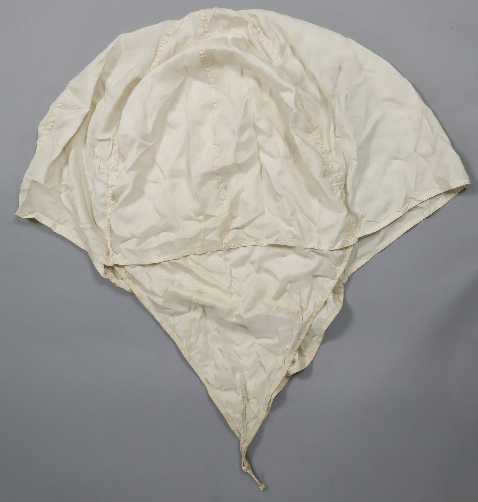 JAPANESE WORLD WAR II ‘PILOT CHUTE’: A Japanese silk ‘pilot chute’ designed to pull the main chute of a military parachute, approx. 19 in. dia., stamped in black with factory emblem and manufacturing serial number