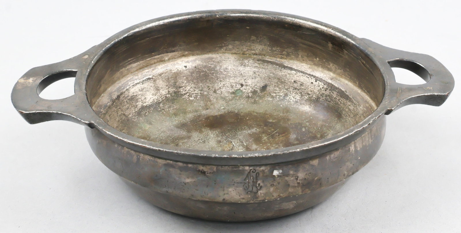 LIEBSTANDARTE ADOLF HITLER CASSOULET: A small pewter cassoulet, or bowl, issued for use by members of the Liebstandarte Adolf Hitler, originally Hitler's personal bodyguard. The two-handled 7.5 in. wide 40 cl. bowl sits 1 5/8 in. deep
