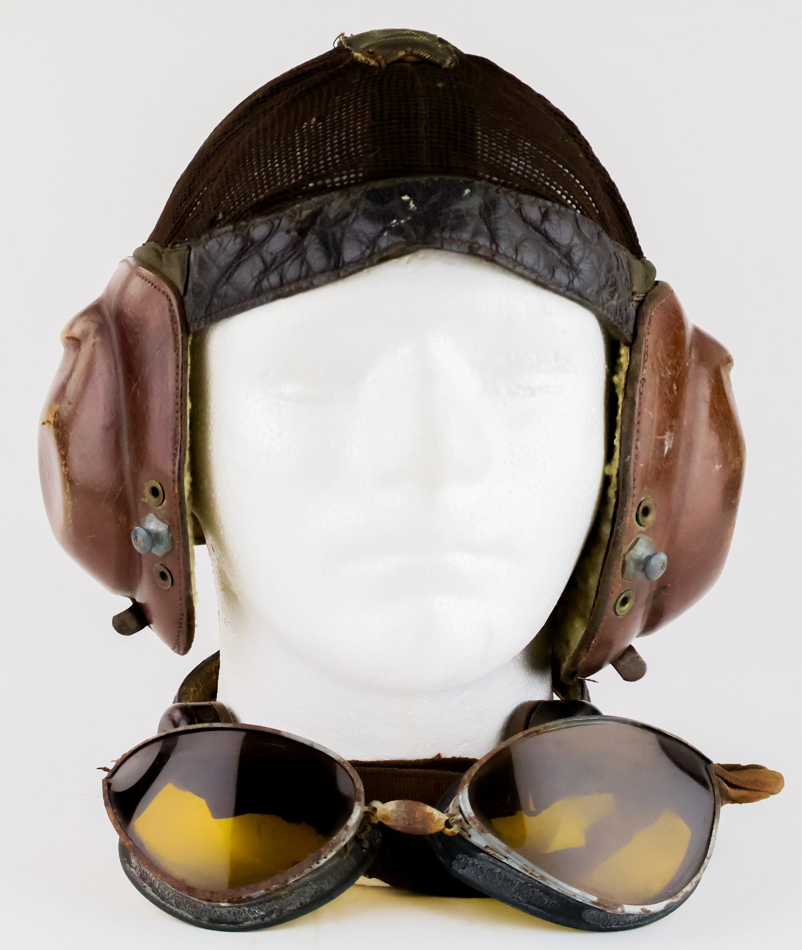 LUFTWAFFE LKPN101 NETZKOPFHAUBE FLIGHT HELMET: A well-known flight helmet, the LKpN101 Netzkopfhaube was very popular with Luftwaffe pilots owing to the mesh covering and the lack of a chinstrap. The original headphones and wool lining remain