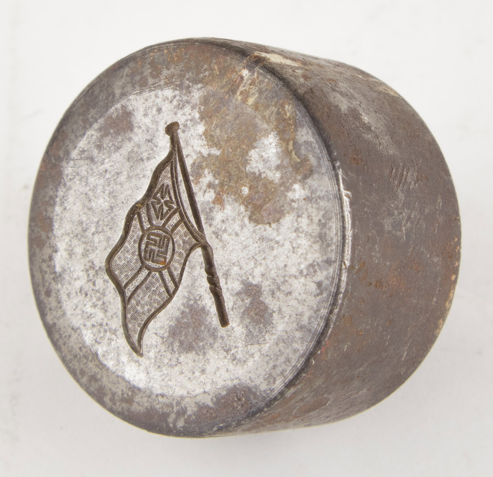 REICHSKRIEGSFLAGGE METAL DIE STAMP: Heavy metal die stamp, 2 x 2 in. tall, the impression of the German war flag on the bottom. Notable oxidation, though the image remains very clear.