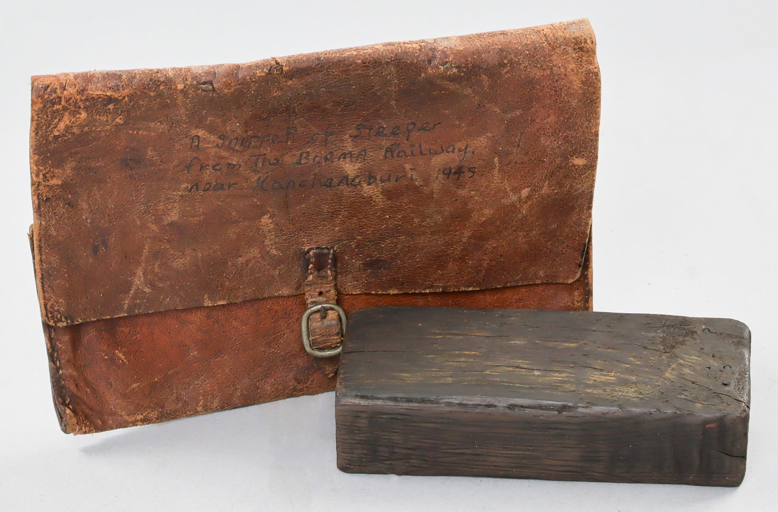 RELIC OF THE BURMA ‘DEATH RAILWAY’: A relic of the infamous Burma Railway, constructed between 1940-43 through the forced labor of Japanese POWs, a 4.5 x 1.5 x 1.25 section of wood from a sleeper car from the Burma Railway in 1945. The