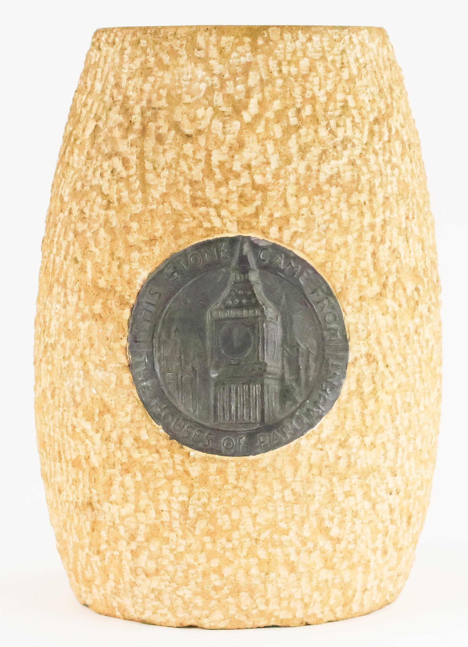 STONE VASE MADE FROM A BOMBED SECTION OF THE HOUSES OF PARLIAMENT: A fine relic from the London Blitz, a vase fashioned from limestone which was once used in the construction of the Houses of Parliament in London, most likely the House of Commons. The 7.25 x 4.75