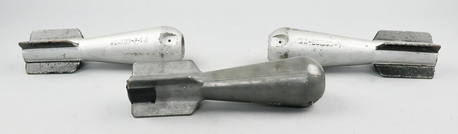 U.S. PRACTICE BOMBS (3): Lot of three World War II-era U.S. practice bombs, each 8 1/4 in. long by 2 in. dia., two examples being the cast-iron An-Mk23, and the third being the cast-lead Mk 43 Mod 1. The end of each bomb