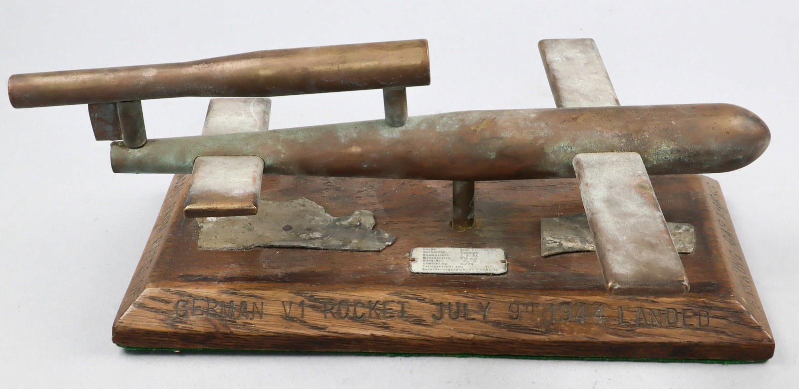 V-1 ROCKET TRENCH ART WITH ROCKETS RELICS: An interesting wartime V-1 piece comprised of a piece of trench art, 12.5 in. wide, 5.25 in. deep, approx. 5 in. tall. The display is comprised of a simply constructed model of a V-1 rocket