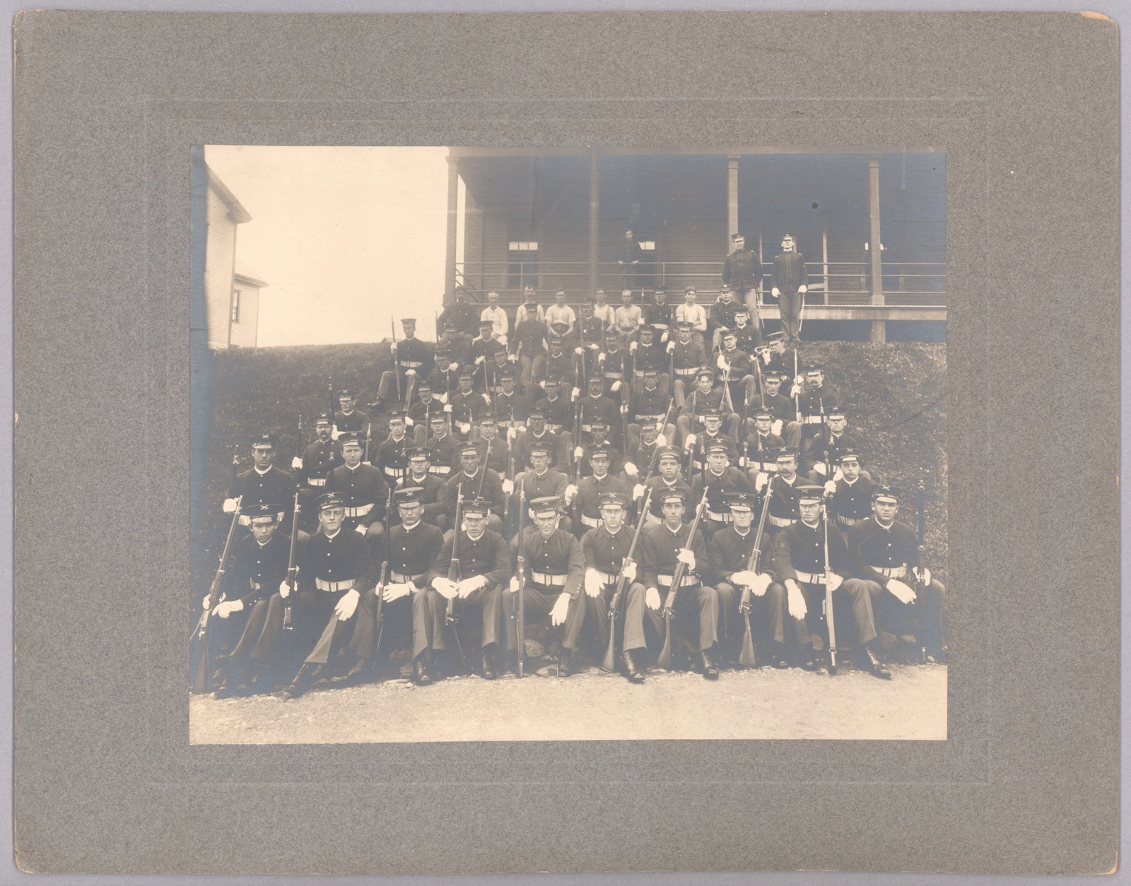 WORLD WAR I PHOTOGRAPHS: Two fine images: the first, 9.5 x 7.5 in. b/w on a 14 x 11 in. mat, shows a regiment of artillery soldiers in uniform. Pencil on verso reads: ‘5/6/06 Ft. Guble [sic, Greble]’. Fort