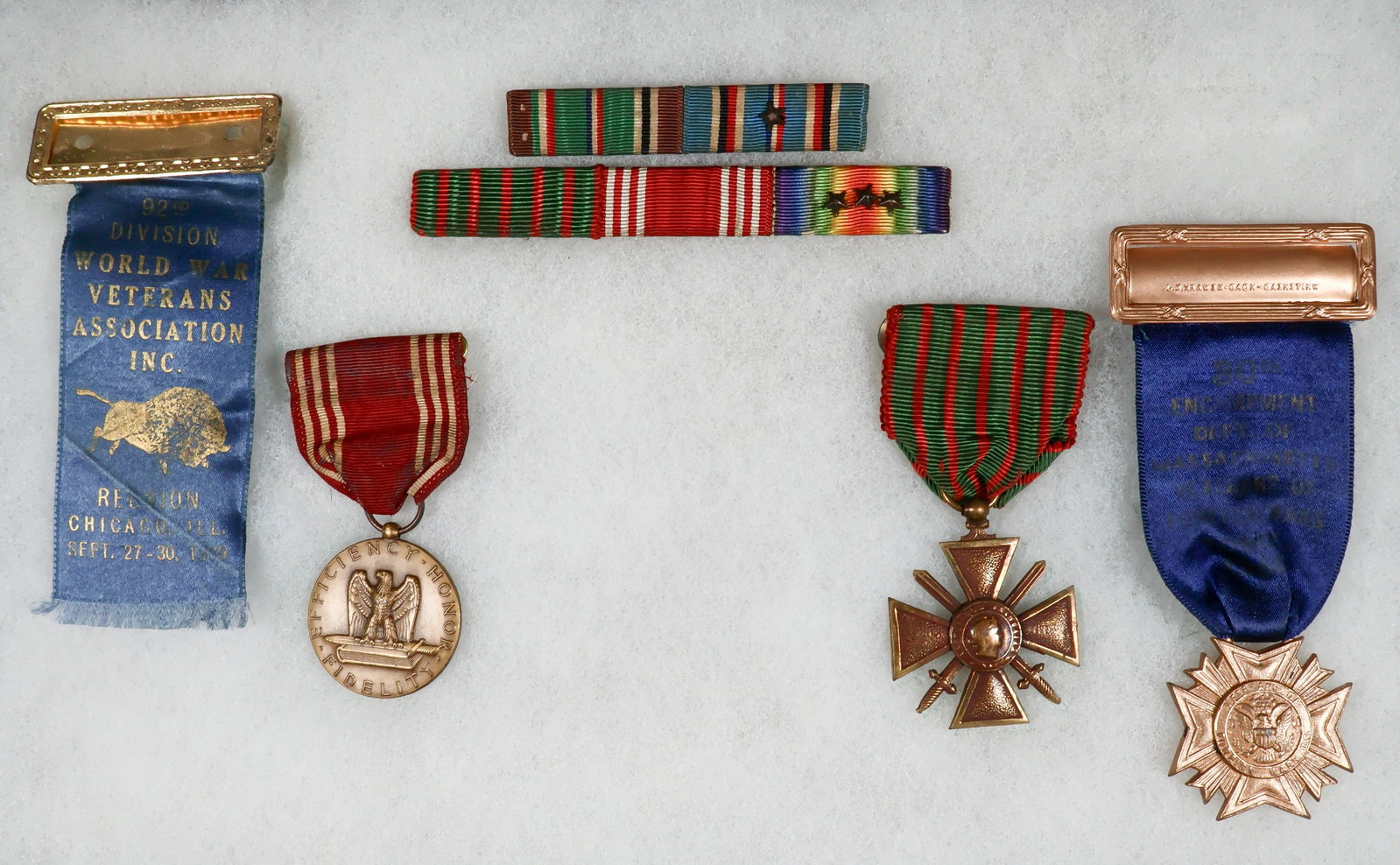 BLACK 92ND DIVISION MEDAL AND RIBBON BAR GROUPING (6): Fine lot of six items belonging to black Army soldier Leroy J. Reynolds, a member of the 92nd Infantry Division ('Buffalo Soldiers'). Included is Reynolds' Army Good Conduct Medal, engraved 'Leroy J.