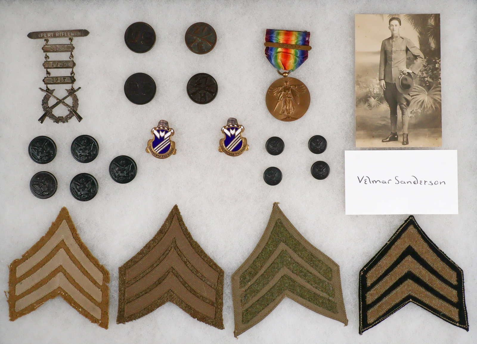 27TH INFANTRY SOLDIER'S 'SIBERIA' MEDAL AND INSIGNIA: Good set of medals and insignia from a sergeant attached to the 27th Infantry identified as 'Velmar Sanderson' who served in the AEF Siberia Expedition at the end of World War I. Included in the