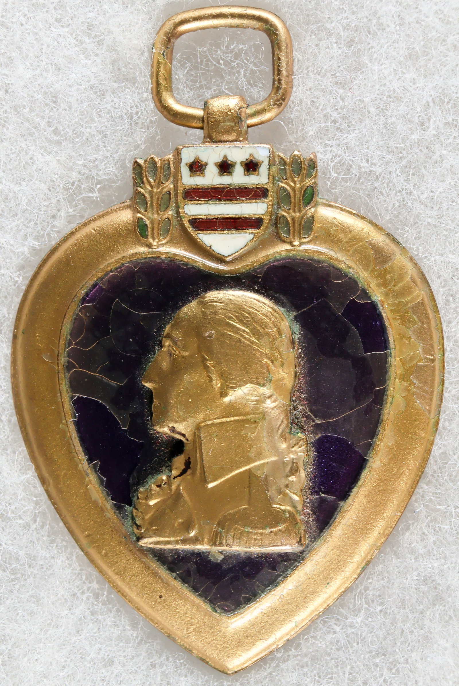 PURPLE HEART ISSUED TO A GASSING VICTIM: Purple Heart awarded to Pvt. John R. Barard, Co. l, 312th Infatry Regiment, nicely engraved with his name in balck on reverse but protective layer over purple field on obverse lifting slightly,