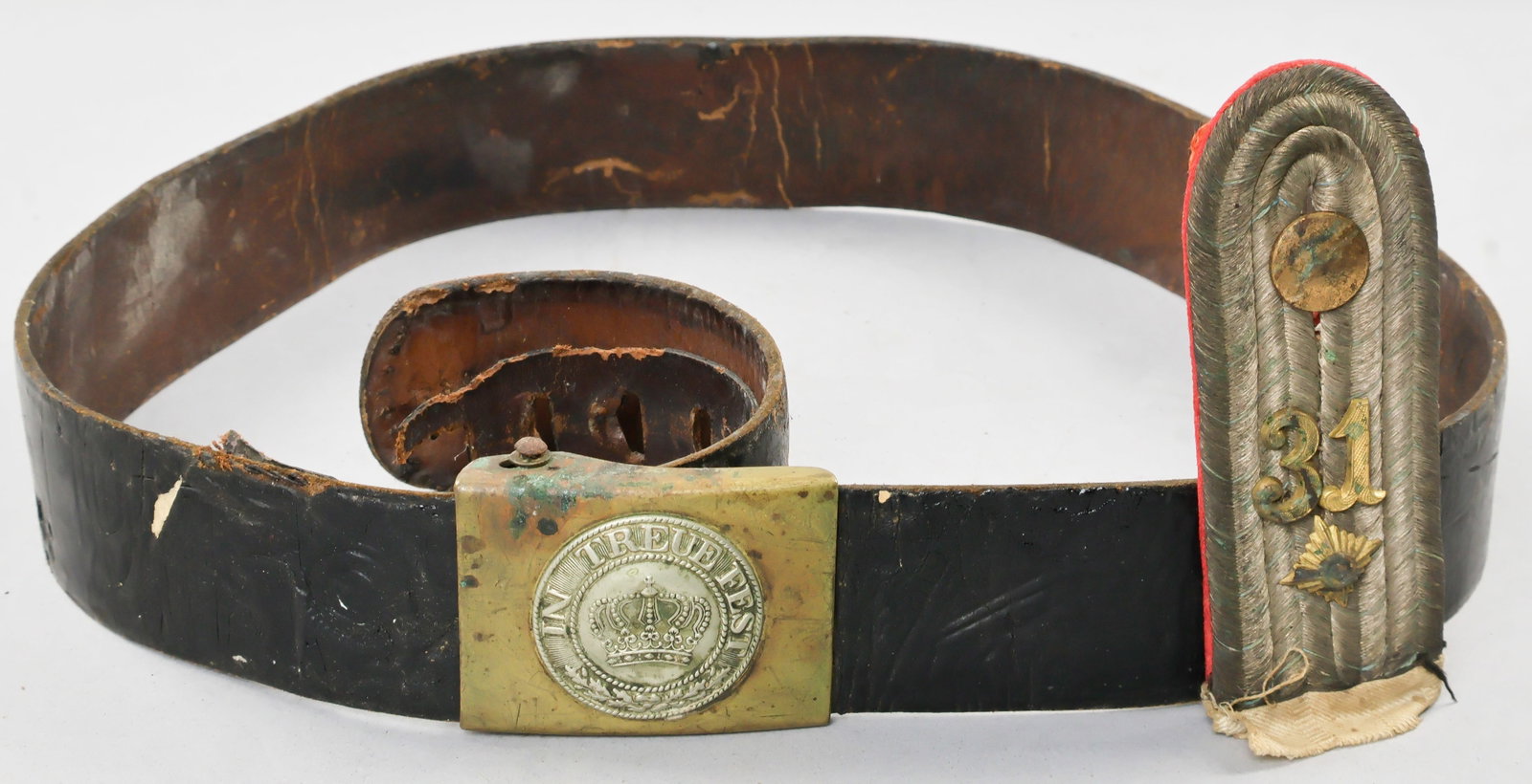 WORLD WAR I BAVARIAN BELT AND SHOULDER BOARD: Scarce steel box-style uniform belt buckle, 2.5 x 2 in., stamped with a crown within a sunburst emblazoned with the motto ‘In Treue Fest’ (‘Steadfast and True’), indicating use