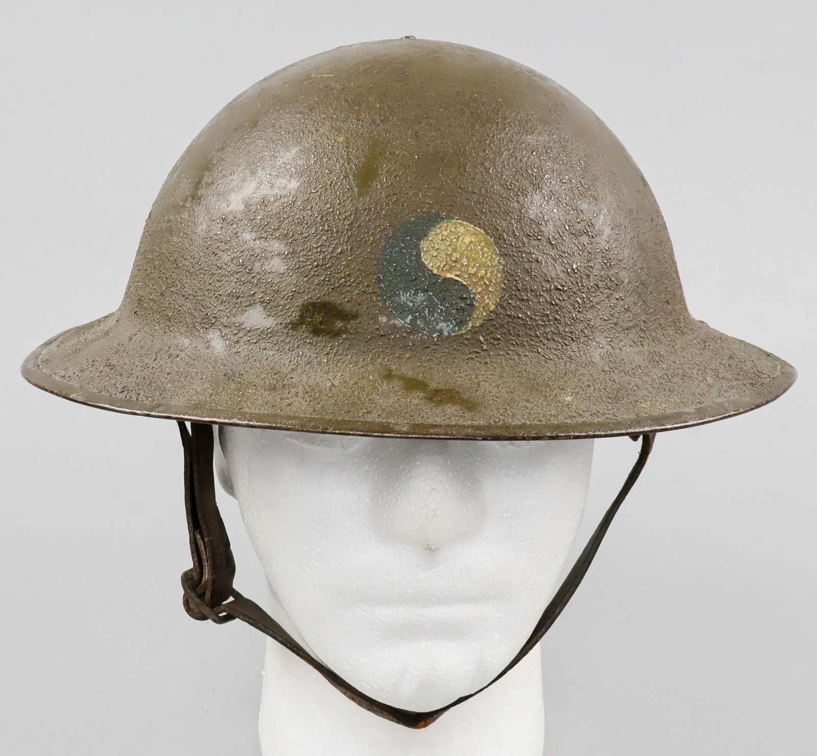 29th INFANTRY DIVISION PAINTED M1917 HELMET: A fine example of a World War I U.S. soldier’s M1917 steel combat helmet, retaining its original green-brown sawdust-textured finish. Most notably, the front of the helmet displays the hand-pain