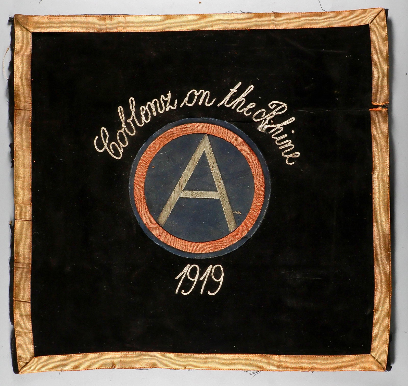 THIRD ARMY OCCUPATION OF GERMANY BANNER AND PHOTO: Small banner used by a U.S. Third Army unit during their occupation of Coblenz, Germany in 1919, 17 x 16 in. thick black felt cloth with the emblem of the Third Army embroidered at center with silver