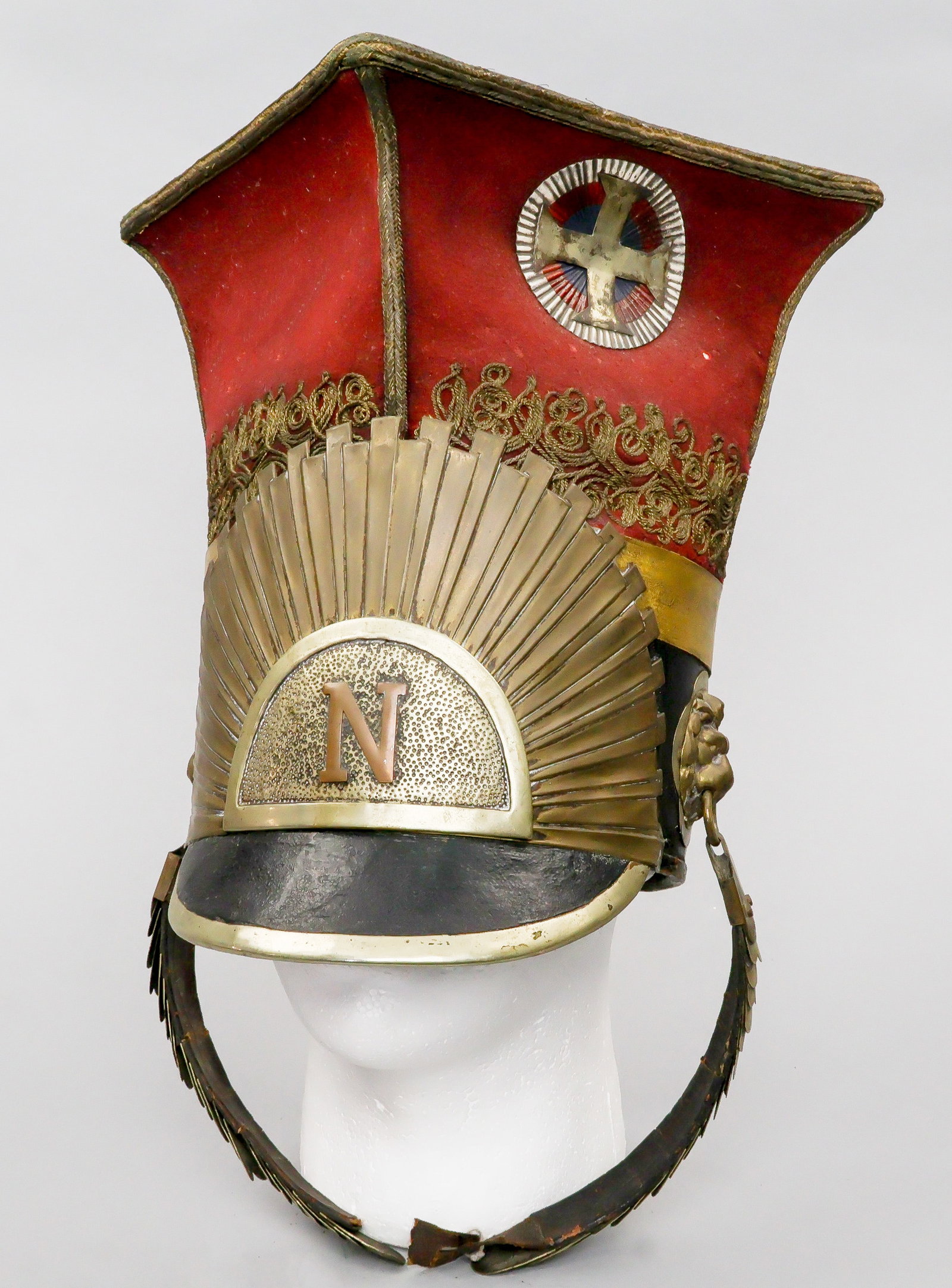 NAPOLEONIC POLISH LANCER CZAPKA: Napoleonic Polish Lancer's Czapka, a high, four-pointed cap with regimental insignia applied at near the top. This piece of headgear stands 11.5 in. tall. It bears a black-painted leather brim with