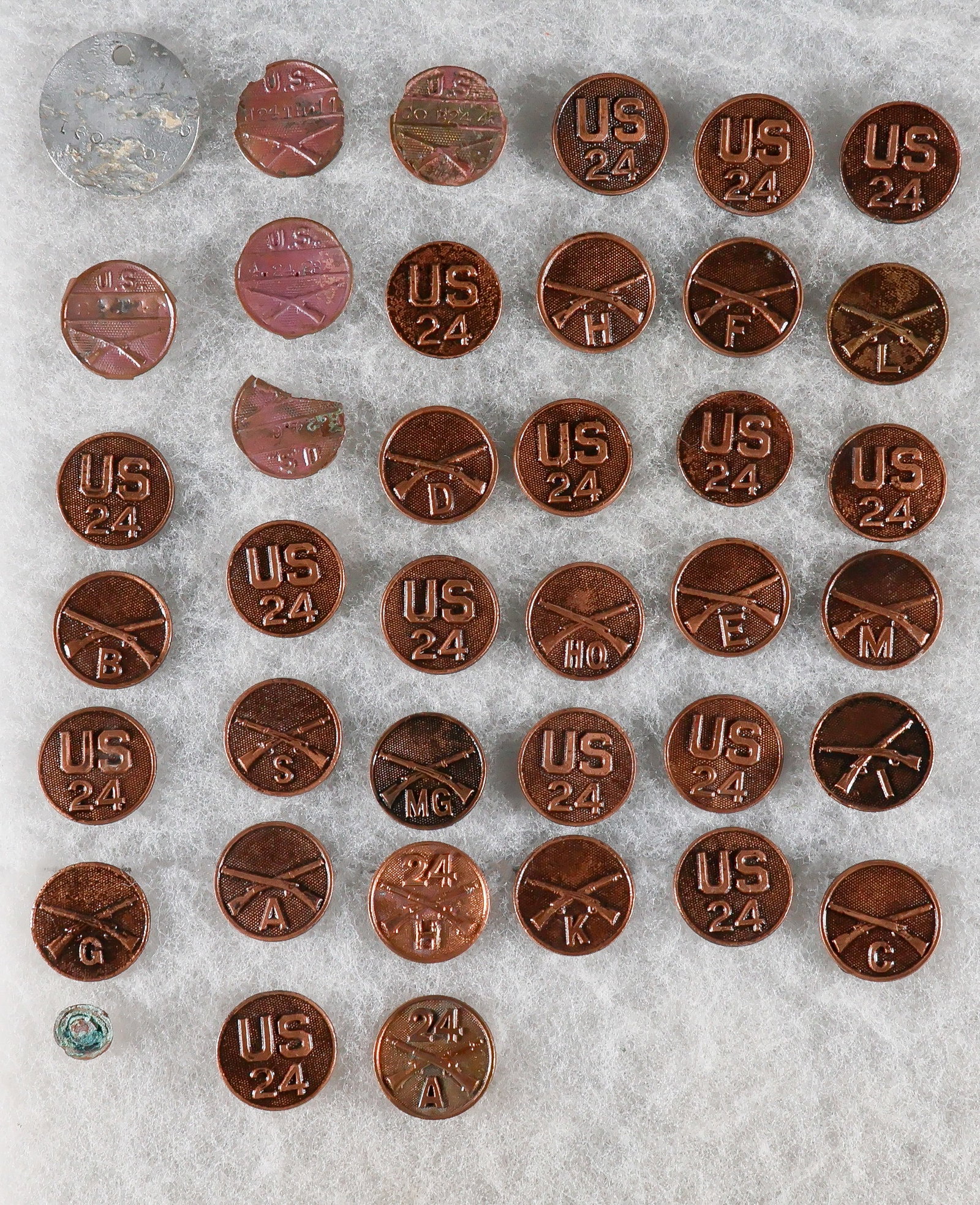 BLACK 24TH INFANTRY 'BUFFALO SOLDIER' COLLAR DISCS (37): Large set of 32 pairs of 24th Infantry Regiment collar tabs from various companies of the famous 24th Infantry 'Buffalo Soldiers', all ca. 1916-17, includes Companies A (2 sets), B, C, D, E, F, G, H, 