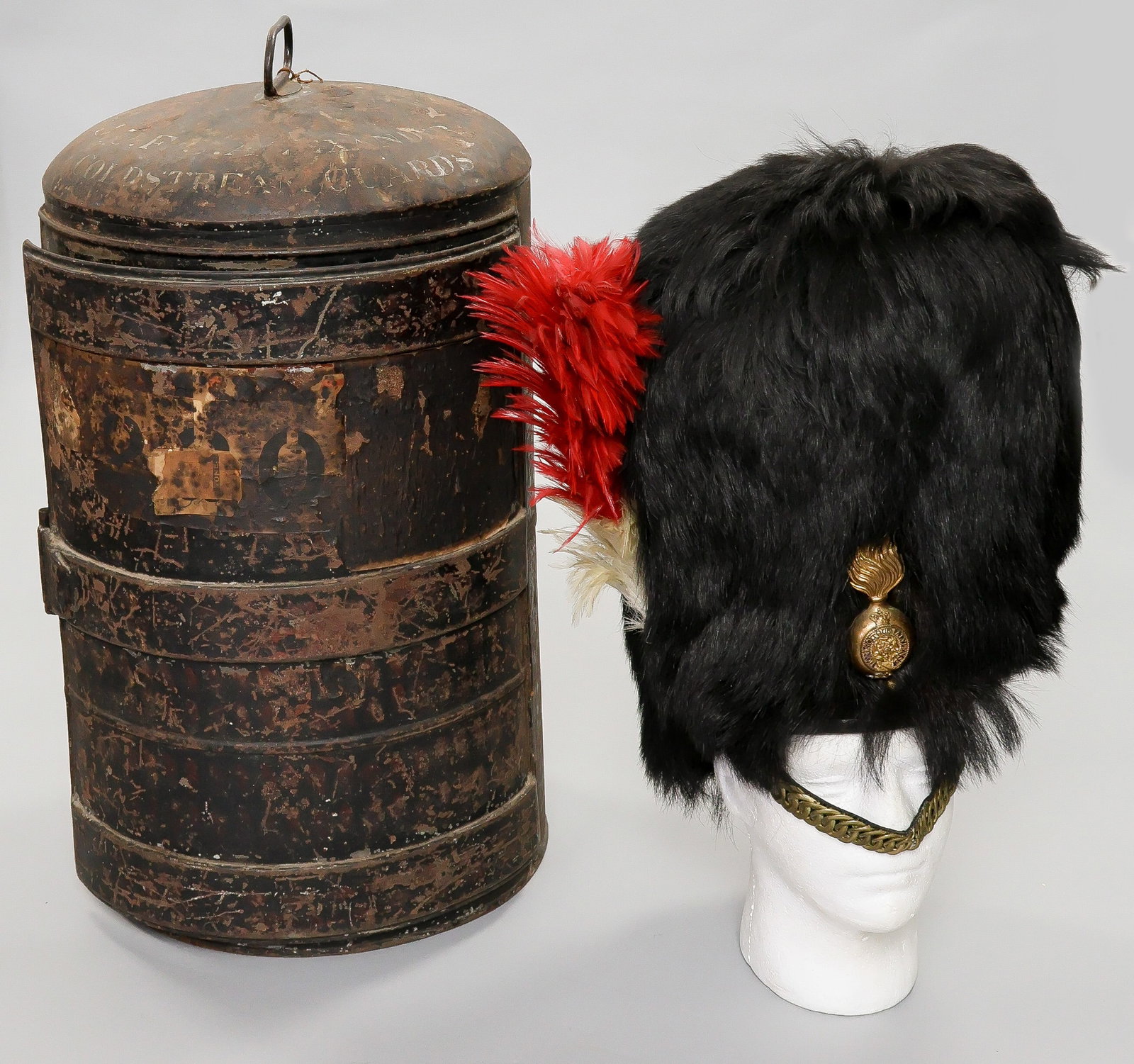 ROYAL REGIMENT OF FUSILIERS BEARSKIN PARADE CAP: Scarce ca.1940s Royal Regiment of Fusiliers bearskin parade cap, 18 in. tall with red over white hackle, brass chain link chin strap, 'brass 'flaming bomb' insignia fitted to the front, and leather li