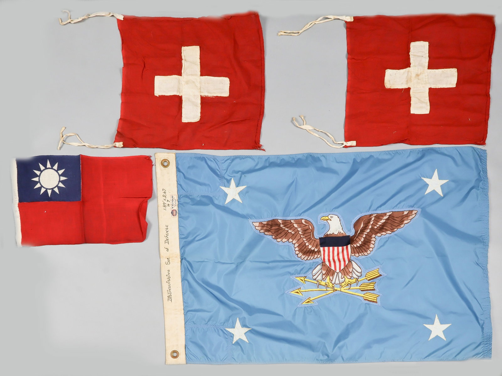 U.S. SECRETARY OF DEFENSE FLAG AND MORE: A post-1947 U.S. flag, 33.5 x 22.5 in., constructed of blue nylon and featuring sewn-on U.S. eagle with shield clutching three arrows, with a sewn-on star at each corner, denoting the U.S. Secretary o