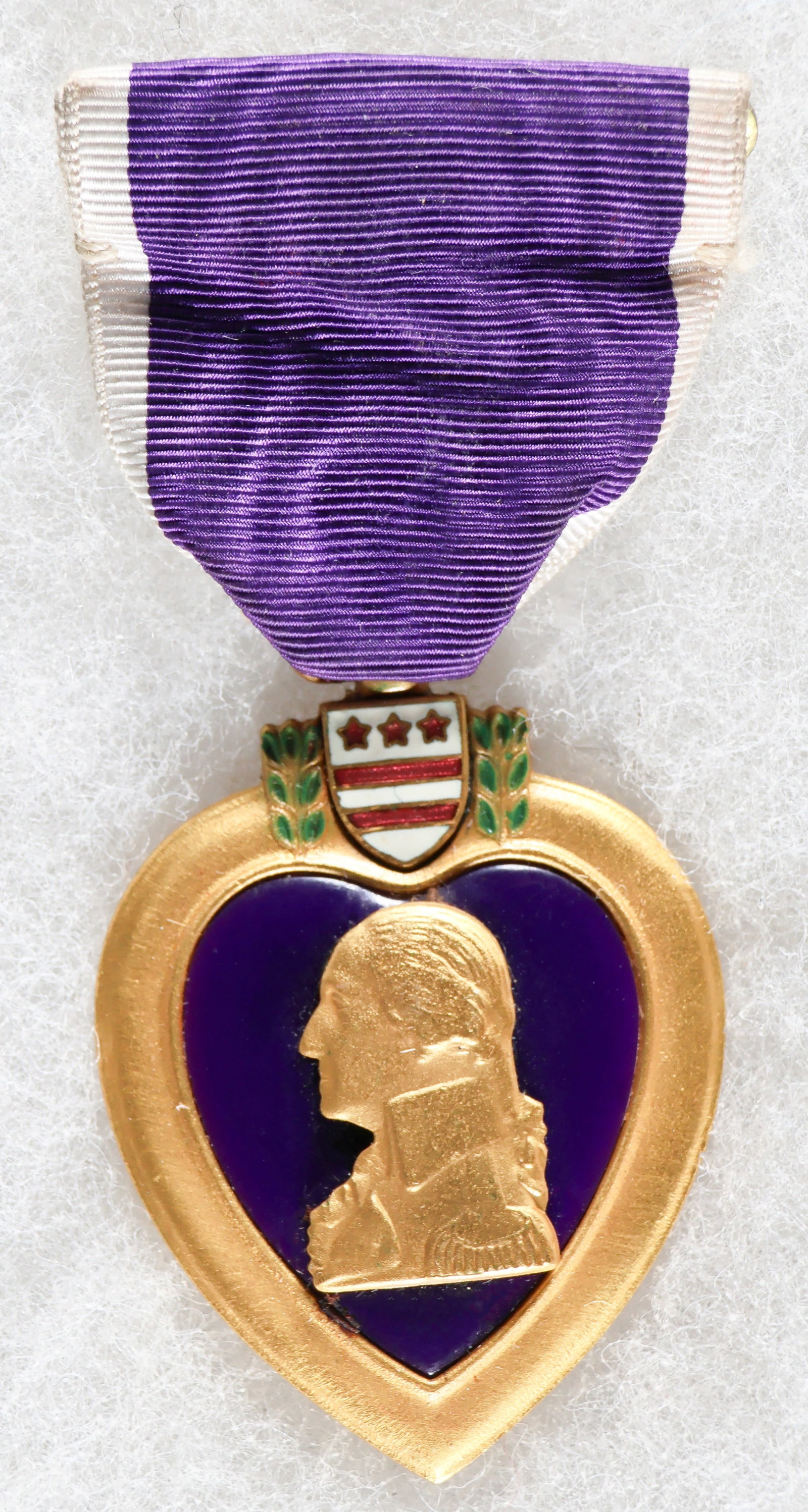 K.I.A. BLACK SOLDIER'S PURPLE HEART FROM THE MASSACRE AT PUSAN, 1950: A most important and evocative medal, the original, engraved Purple Heart medal awarded to black Master Sgt. Tommie L. Long, K.I.A. while fighting the North Koreans along the Pusan perimeter on Aug. 2