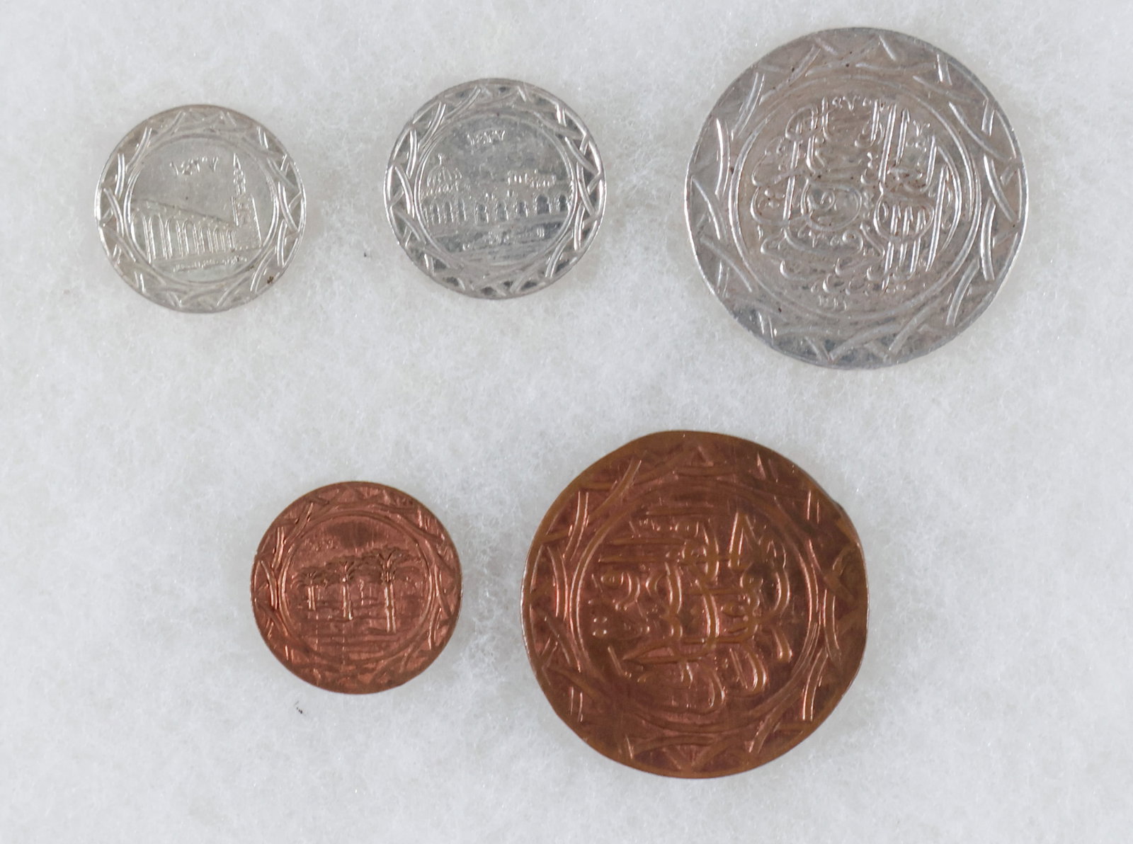 ISIS COINS (5): Very rare set of five ISIS-minted coins used by the terrorist organization and its supporters in lands over which they held control. Includes three silver coins: 1 x five Dirham silver coin,