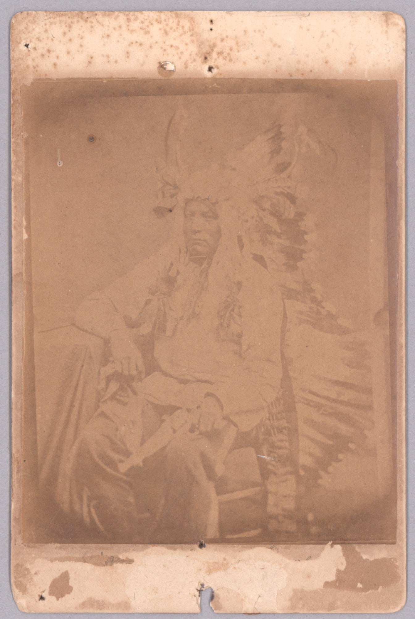 (SITTING BULL'S SON): A cabinet photograph showing Sitting Bull's son with note on verso reading: 'Sitting Bull's Son This man refused to have his picture taken unless his revolver was ready for instant use...'. No