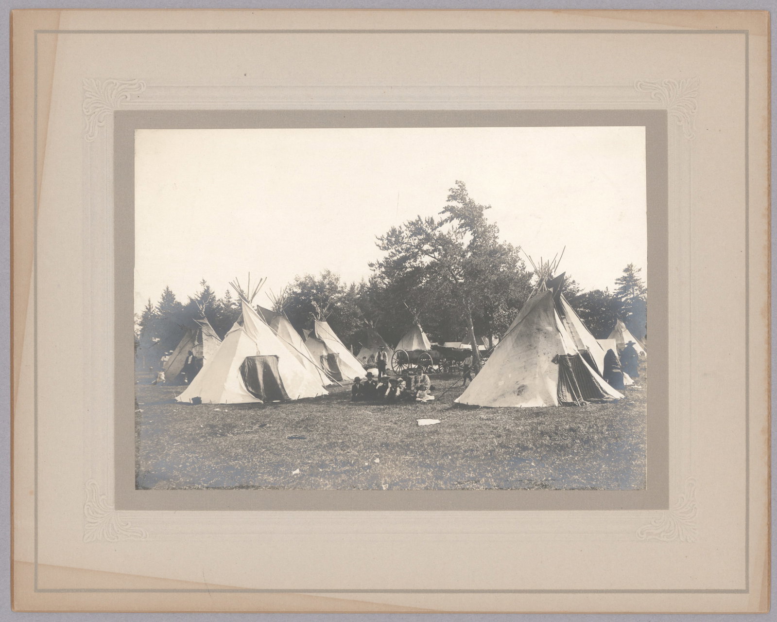 PHOTO OF A SIOUX INDIAN CAMP, 1891: A fine photo, 7 x 5 in. on a 10 x 8 in. mount, that shows a Sioux Indian camp in Pine Ridge, 1891 according to the note on verso by the photographer, Dr. J. R. Collard. Light offsetting to mount,