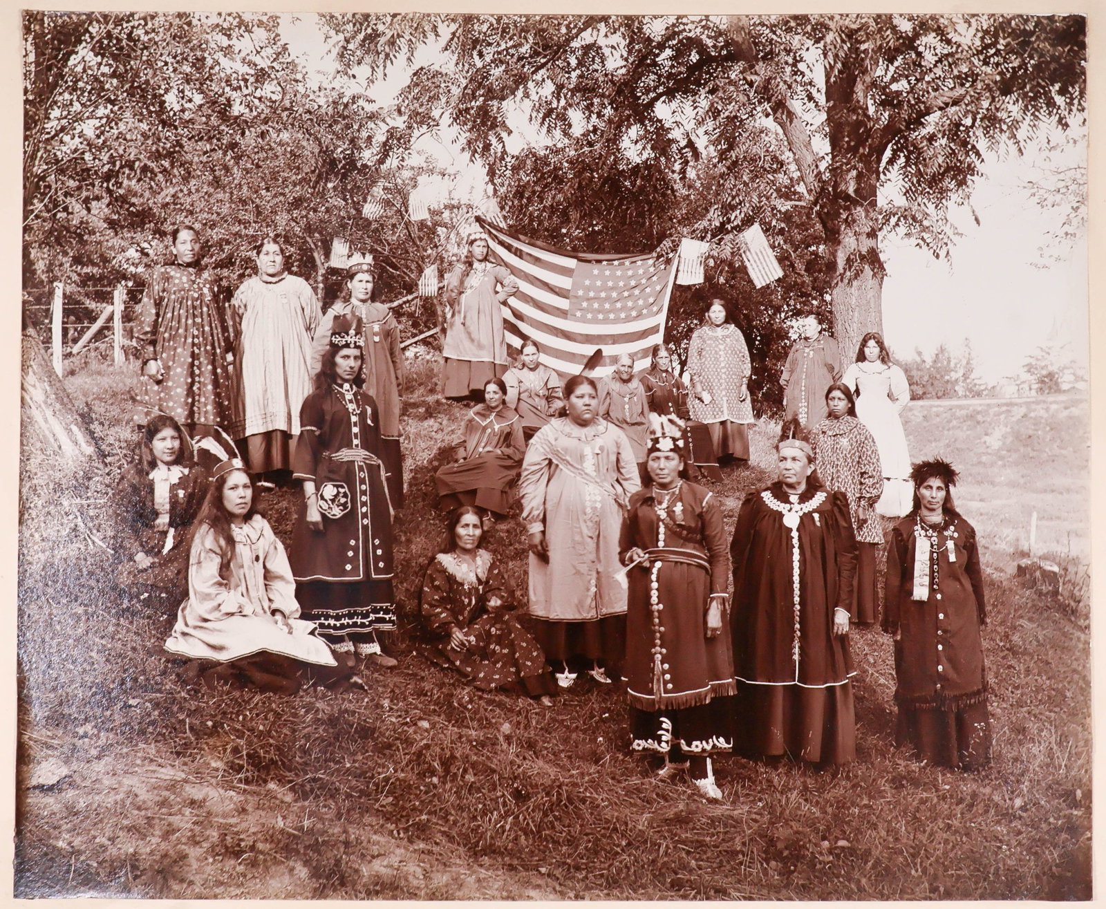 CIVIL WAR ERA NATIVE AMERICAN WOMEN: An interesting Civil War era photograph, image 11 x 9 in. mounted to a 17 x 14 in. mat, shows a group of Native American women and children in western dress, with some wearing medals, sashes and