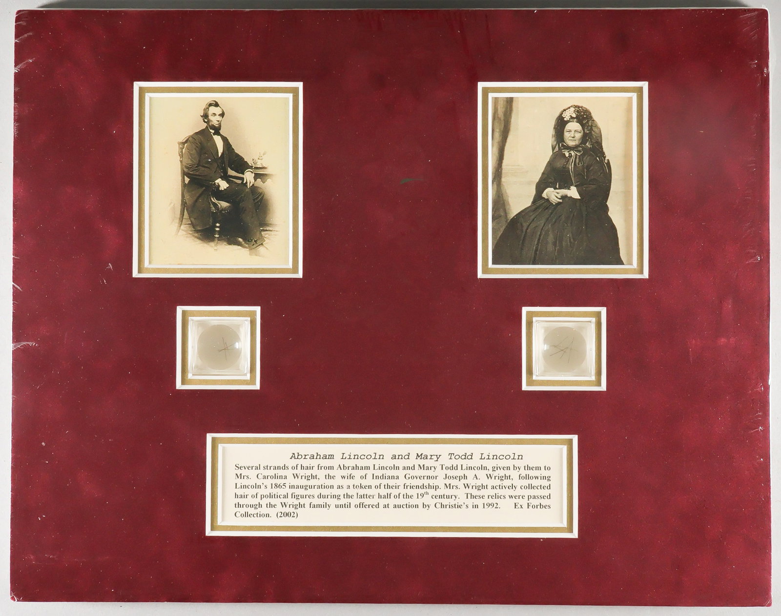 ABRAHAM AND MARY LINCOLN HAIR DISPLAY: A fine pair of Lincoln relics, a total of about ten strands of hair of both Abraham Lincoln and Mary Todd Lincoln, separately contained within small magnifying cases matted beneath reproduction