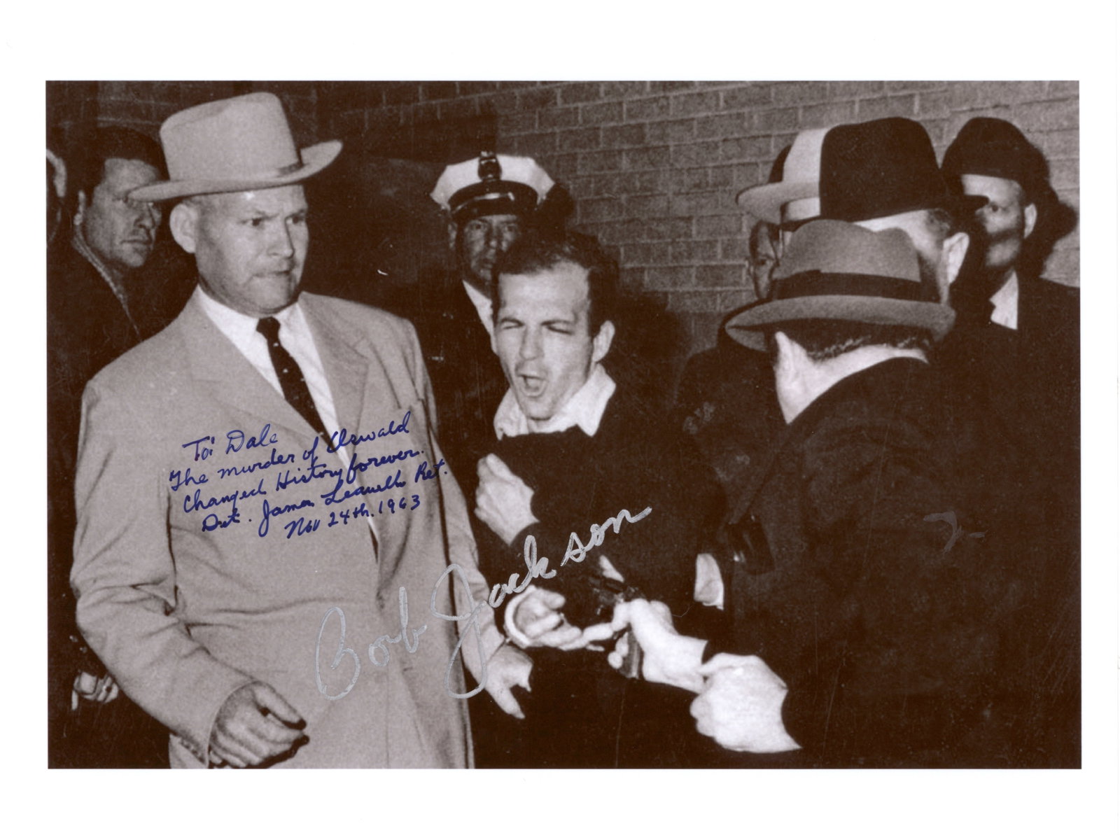 THE MURDER OF LEE HARVEY OSWALD: Excellent S.P., 10.5 x 8.5 in. b/w, the iconic photograph of Oswald at the moment he was shot by Jack Ruby, signed by the Pulitzer Prize-winning photographer ROBERT H. JACKSON (b. 1934). Also signed