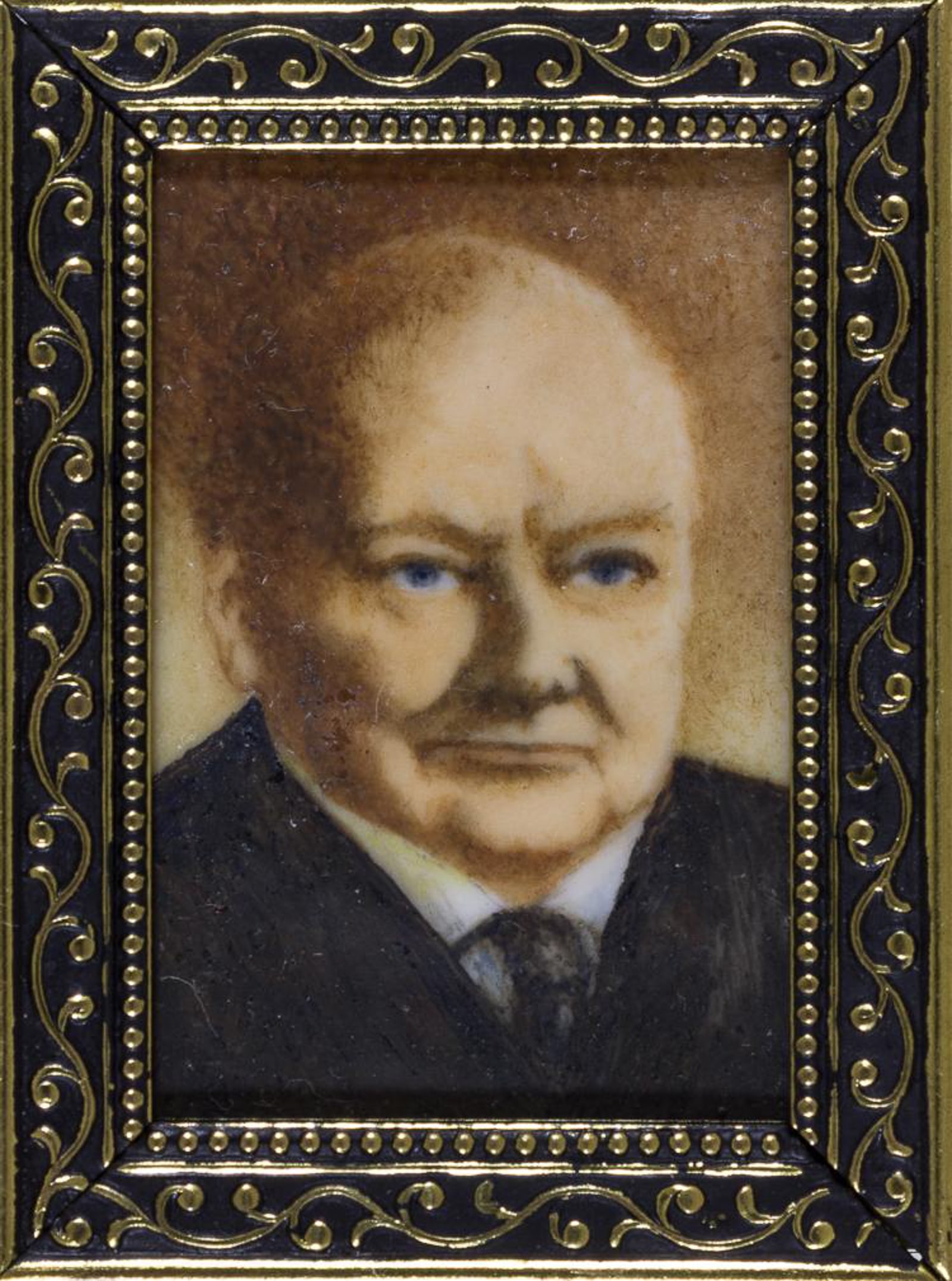 WINSTON CHURCHILL MINIATURE PAINTED PORTRAIT: Miniature acrylic painting of Winston Churchill on celluloid, 2 x 2.5 in., unsigned but by painter, calligrapher and illuminator JOAN PATRICIA CARTER (1923-2015), member of the Royal Miniature