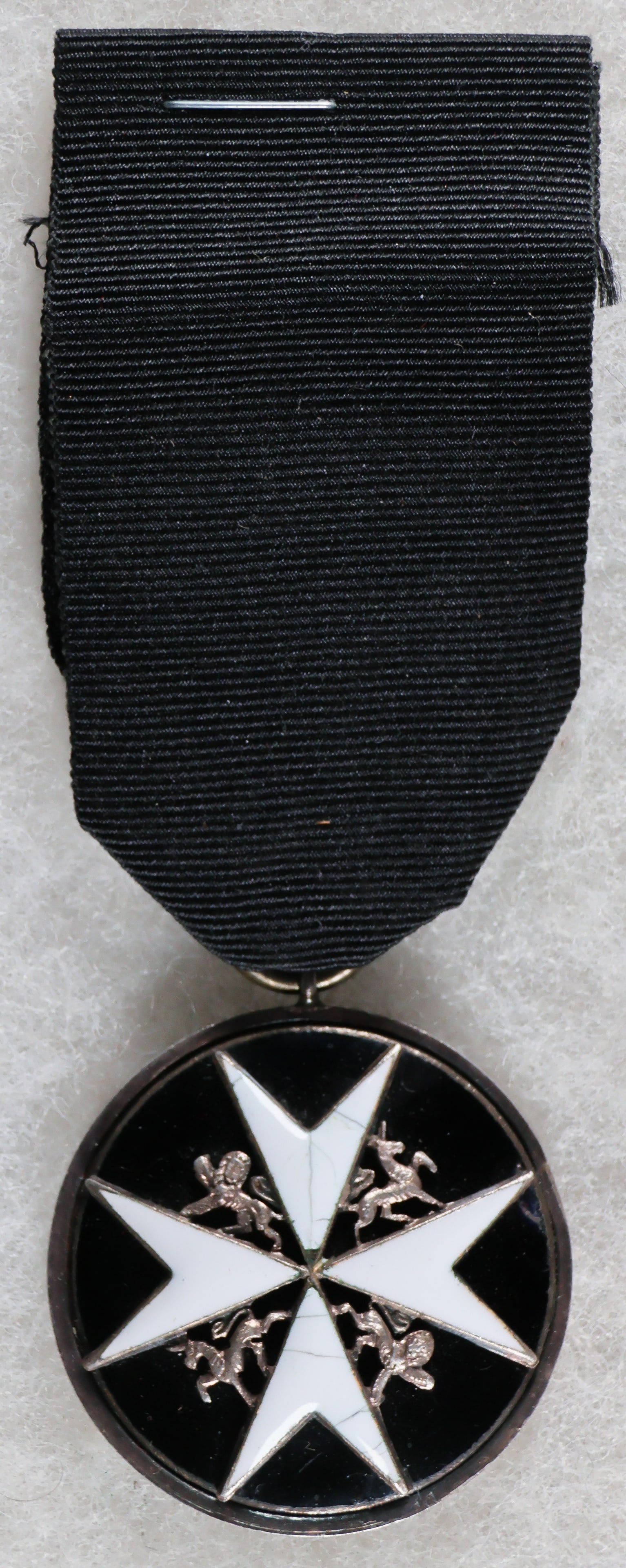 ORDER OF ST. JOHN, SERVING BROTHER BREAST BADGE, PRE-1949: Circular silver and black and white enamel breast badge with loop for ribbon suspension; the face with a circular black enamel bombé medallion bearing a white enamel Maltese cross, a silver lion