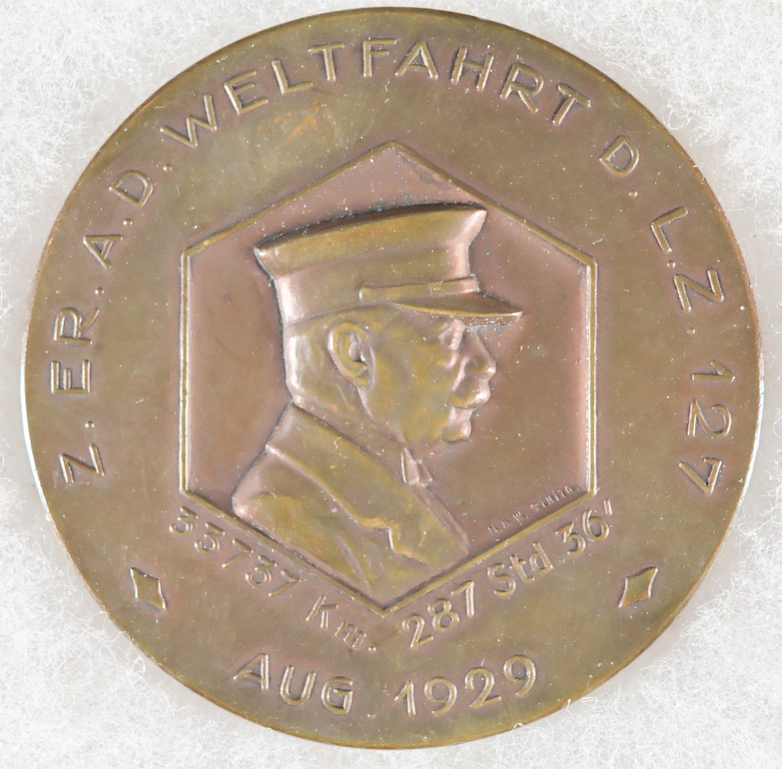 LZ 127 ‘GRAF ZEPPELIN’ CIRCUMNAVIGATION MEDAL: A rare, high-relief copper medal honoring the 1929 world tour of the LZ 127 'Graf Zeppelin', the first circumnavigation by a rigid airship. The medal measures 2.5 in. diameter, and was struck in