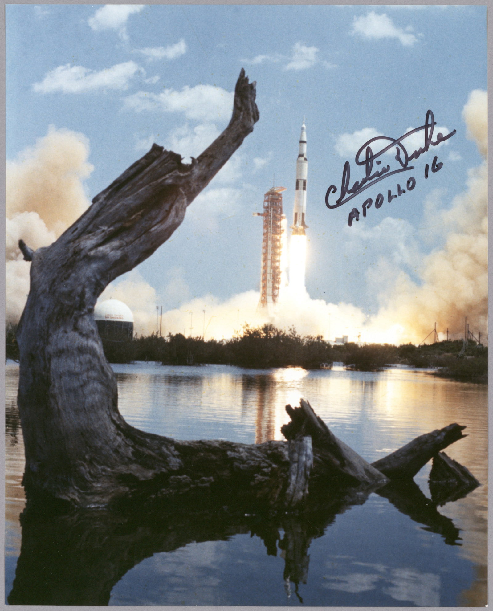 CHARLES M. DUKE: (b. 1935) American astronaut who flew on the Apollo 16 mission, one of only twelve to walk on the moon. Fine S.P. 'Charlie Duke', 10 x 8 in. color, shows the lift off of Apollo 16 with a naturistic vi