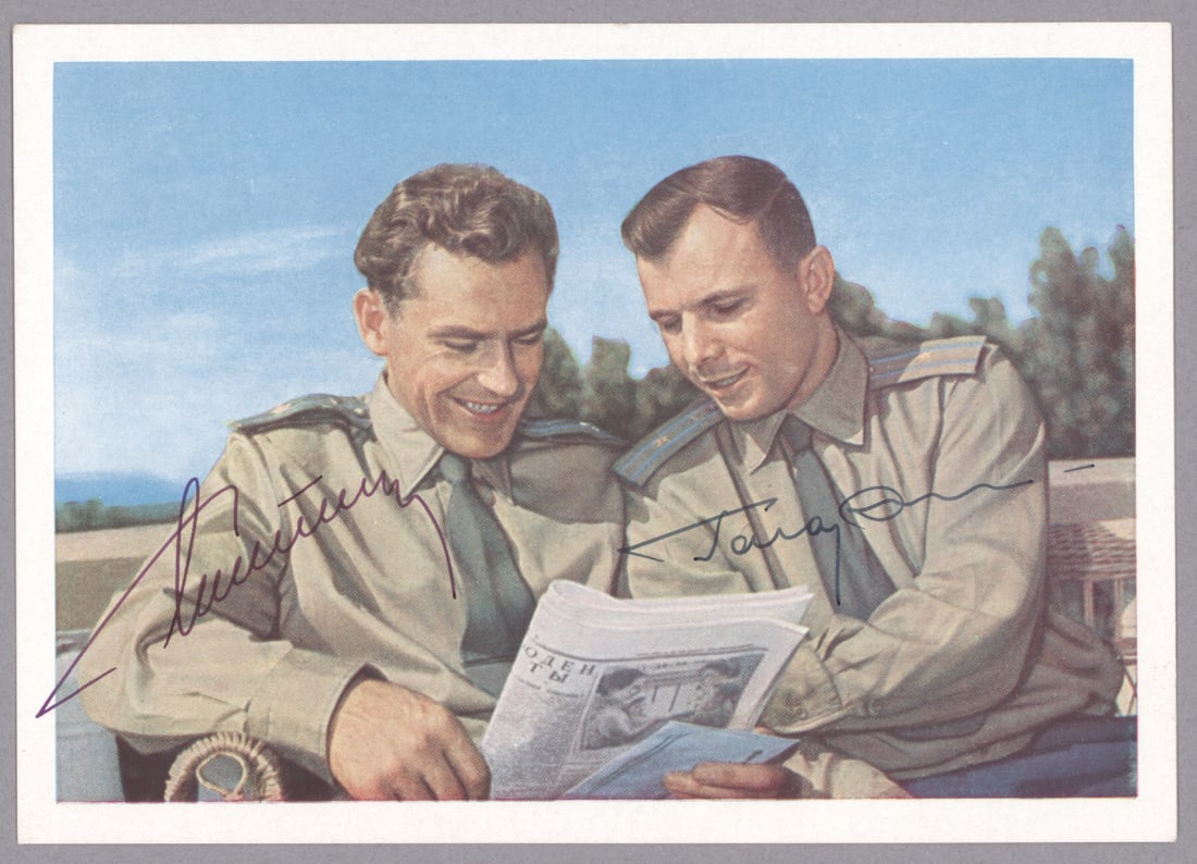 YURI GAGARIN AND GHERMAN TITOV: YURI GAGARIN (1934 - 1968) Russian cosmonaut, the first man in space who died tragically in a routine training flight. Fine S.P. 6 x 4 in., a color postcard, boldly signed by Gagarin and additionally