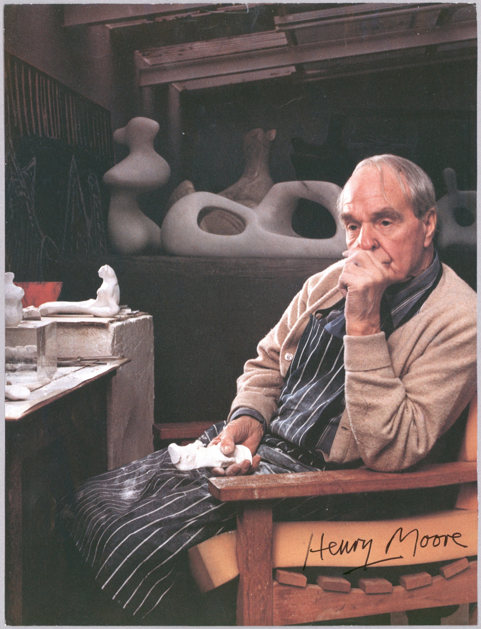HENRY MOORE: (1898 - 1986) British sculptor of abstract works in bronze and stone, often on a monumental scale. Very nice S.P. 8 x 10 in. color on heavy paper stock, a contemplative seated pose of the artist in