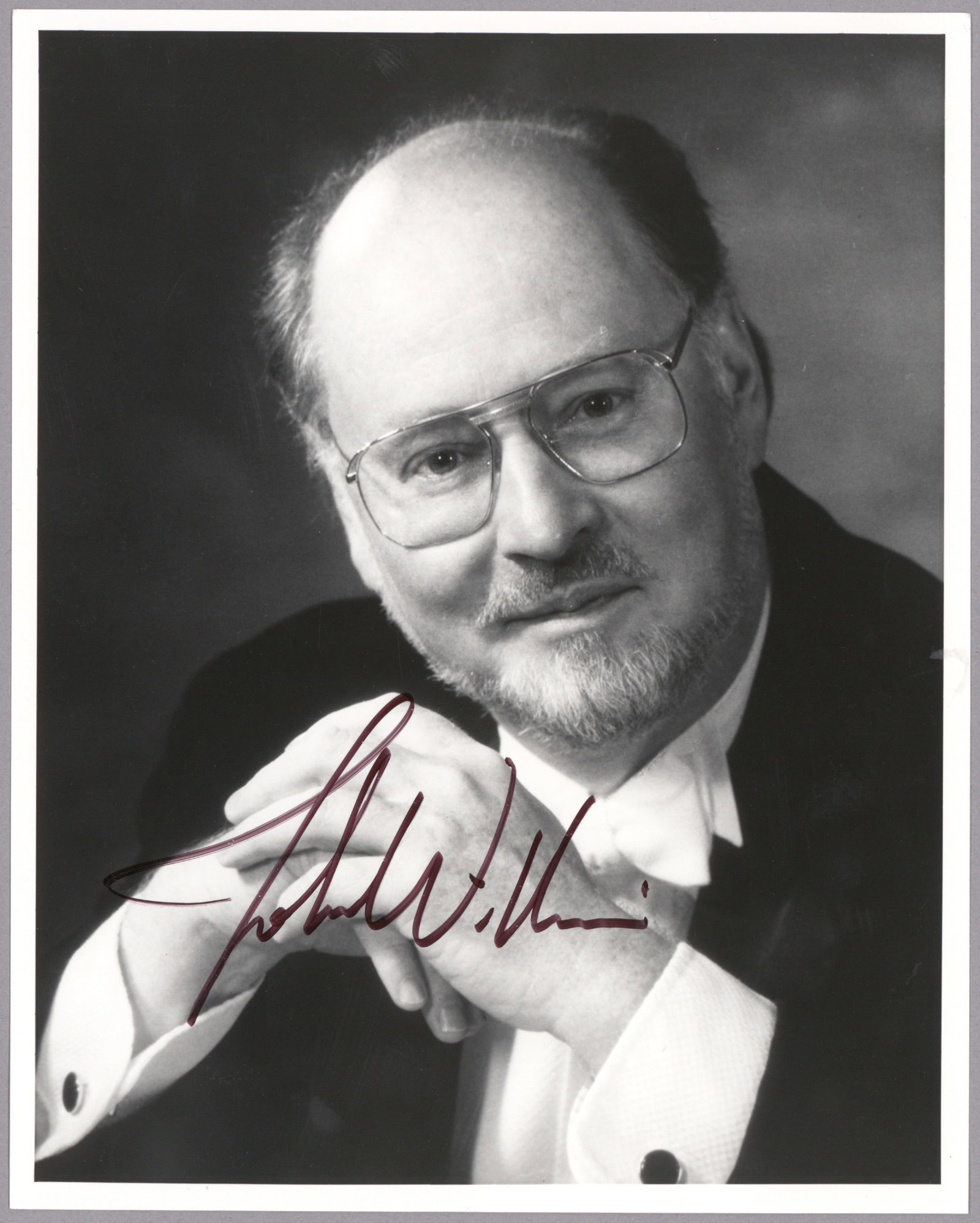JOHN WILLIAMS: (b. 1932) American composer, responsible for some of the most popular and recognizable film scores in cinematic history. S.P. 8 x 10 in. b/w, a head and shoulders portrait, boldly signed. Fine
