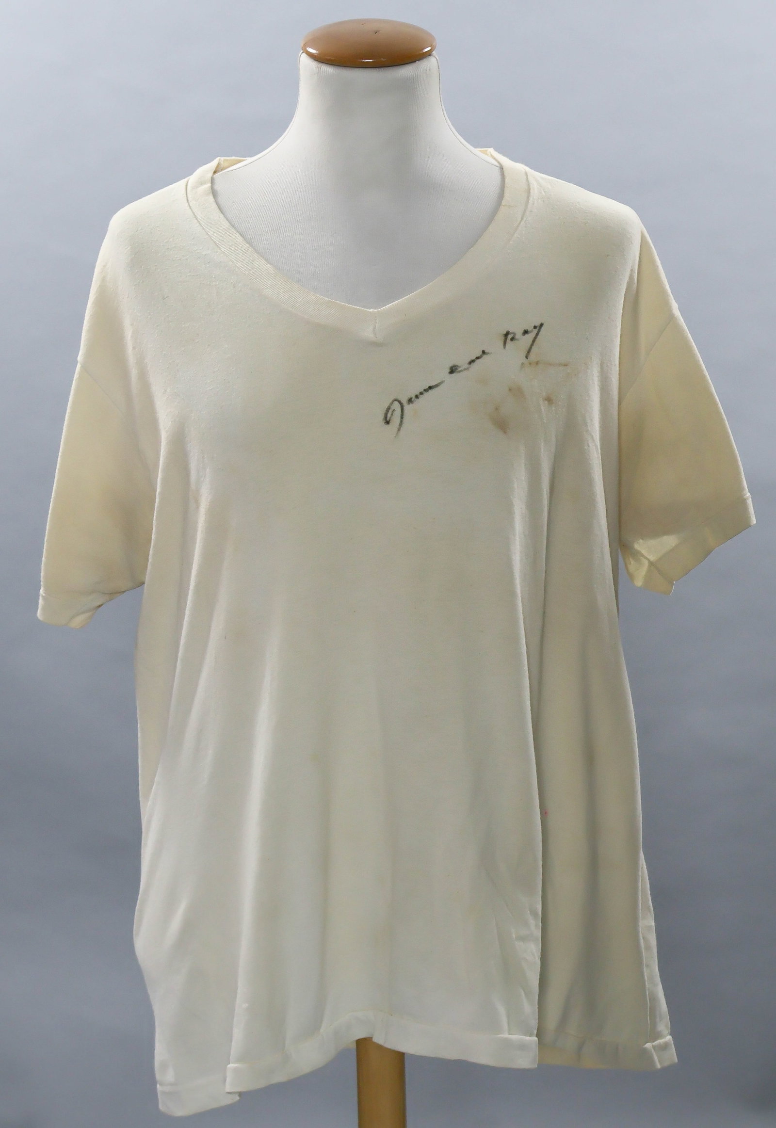 JAMES EARL RAY: (1928 - 1998) Assassin of Martin Luther King, whom he killed in Memphis in 1968. His prison-worn V-neck tan colored t-shirt, signed in black ink, together with a signed 3x5 card. T-shirt bears