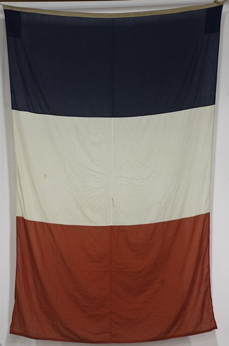 A FLAG THAT FLEW OVER VERDUN: A FLAG THAT FLEW OVER VERDUN Souvenir from the battle of Verdun, a flag that flew over the battlefield ca. 1975, approx. 120" long, 76" along the hoist, cotton, in generally very good condition. The f
