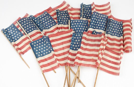 45-STAR FLAGS: 45-STAR FLAGS Lot of 11 flags which most likely once graced the grave of a deceased soldier. Each flag is 9" x 6", printed on a rather coarse fiber and attached to a 17" dowel (two broken). The name "