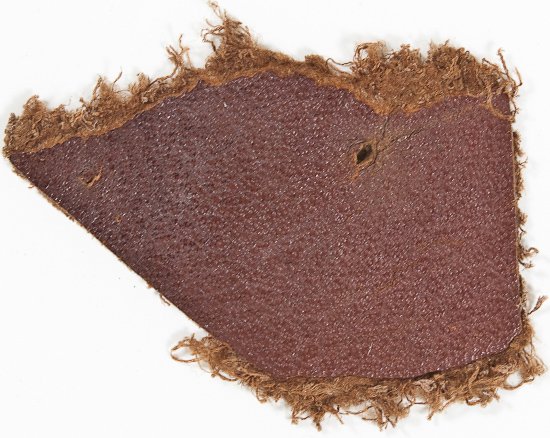 A SWATCH OF LEATHER FROM A CHAIR IN HITLER'S OFFICE: A SWATCH OF LEATHER FROM A CHAIR IN HITLER'S OFFICE An interesting relic from Adolf Hitler's office in the Reichs Chancellery in Berlin, an approx. 1" x 1/2" section of brown dyed leather seat coverin