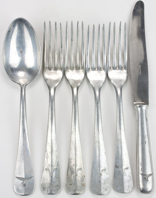 LUFTWAFFE FLATWARE: LUFTWAFFE FLATWARE Lot of six pieces of Luftwaffe flatyware, 8" - 9 1/2" long, all made of cast aluminum (except stainless steel knife blade) and bearing "drop tail" Luftwaffe emblem. Includes four fo