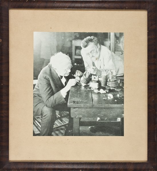 PIONEER ELECTRICITY EXPERIMENTERS: PIONEER ELECTRICITY EXPERIMENTERS A good ca. 1920 paper stock photograph of famed inventors Thomas A. Edison and Charles P. Steinmetz working together on an experiment upon a cluttered table. approx. 