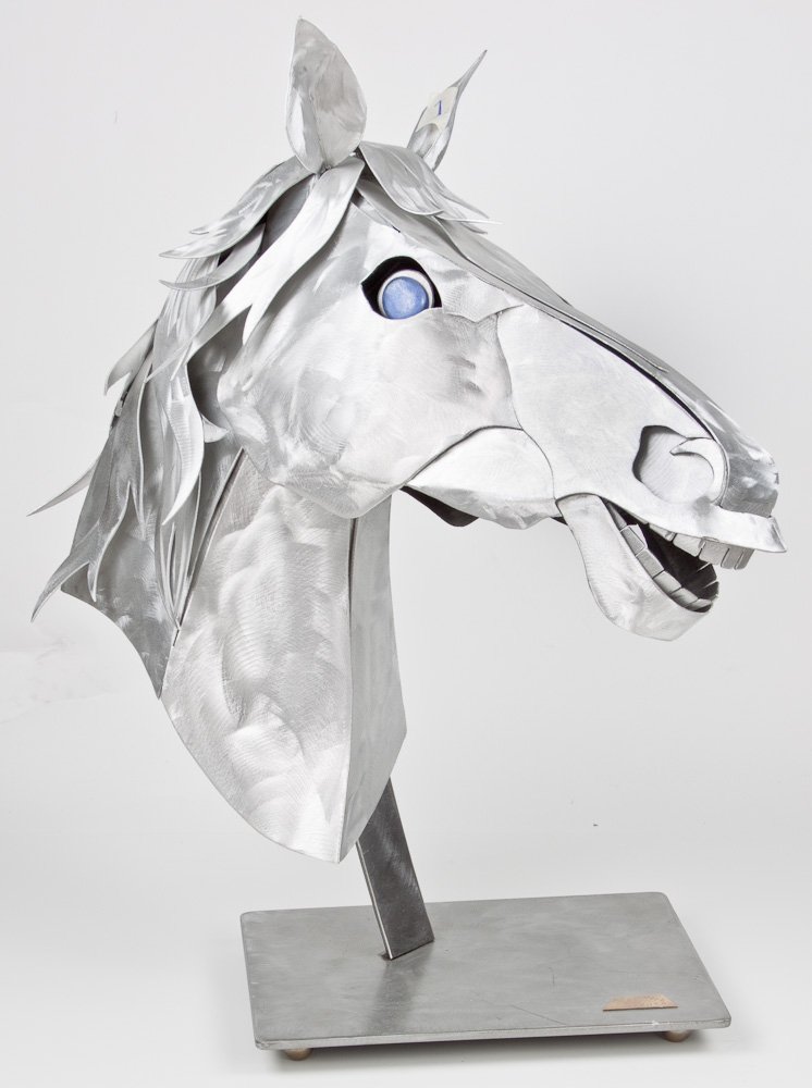 STYLIZED ALUMINUM HORSE HEAD - ALEX KOVACS: STYLIZED ALUMINUM HORSE HEAD - ALEX KOVACS Alex Kovacs (b. Budapest, 1947). Stylized aluminum horse head sculpture, blue glass eyes, with stand, signed by the artist and dated 2006 on a brass plate at